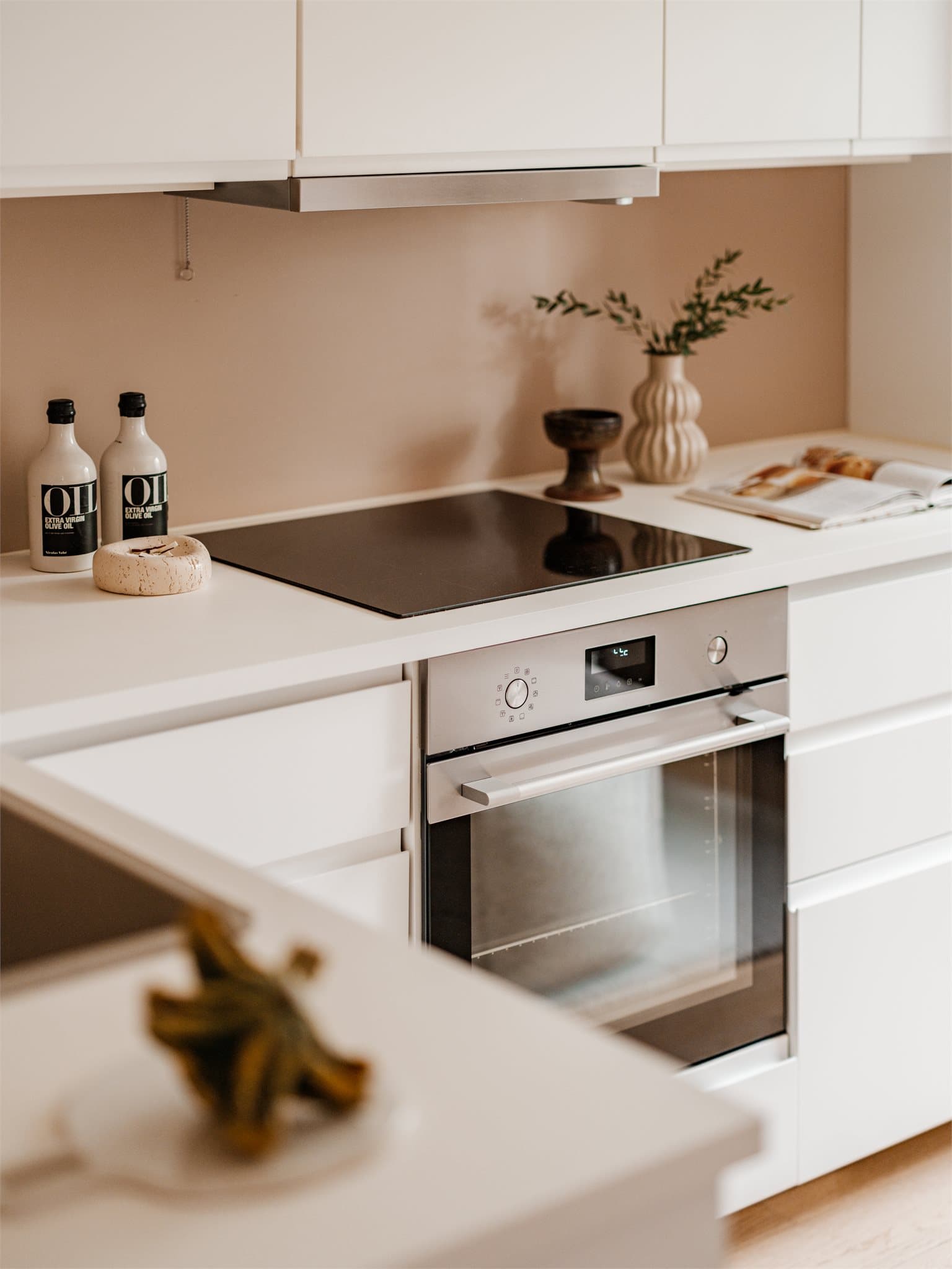 Innredningen har glatte fronter med integrerte håndtak og laminatbenkeplate med oppvaskkum og ettgreps, svingbart blandebatteri. Kjøkkenet er utstyrt med induksjonstopp, innebygget stekeovn samt integrert kjøleskap/fryser og oppvaskmaskin.