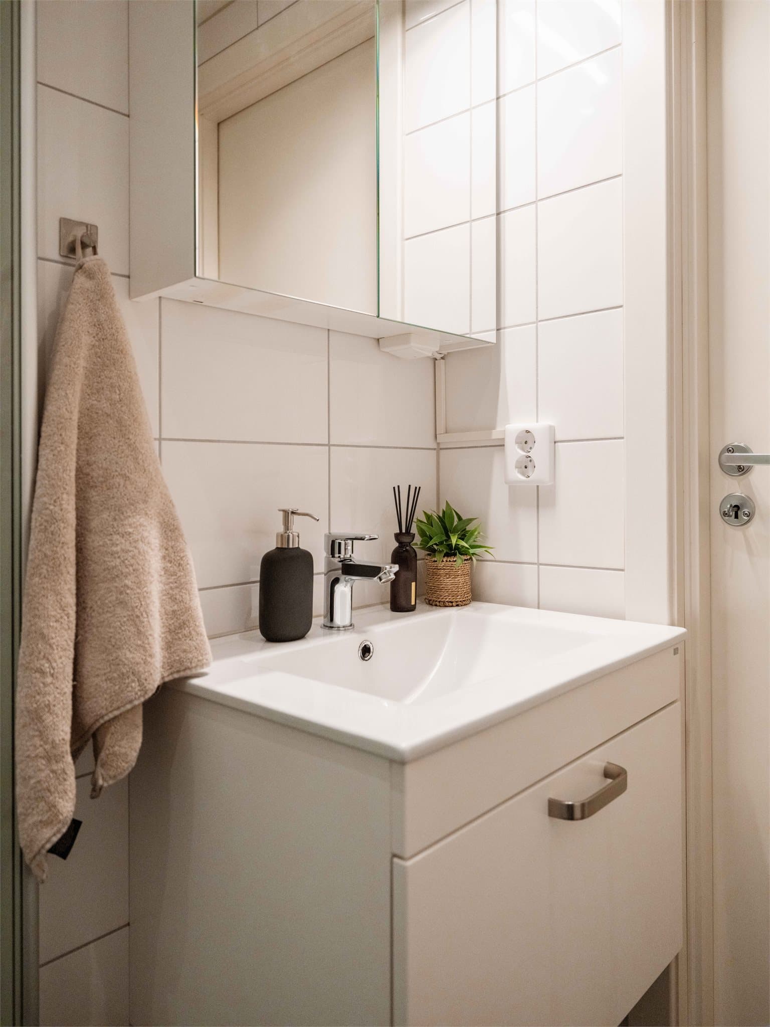 Innredningen består av en servant nedfelt i skap og et praktisk speilskap med belysning.