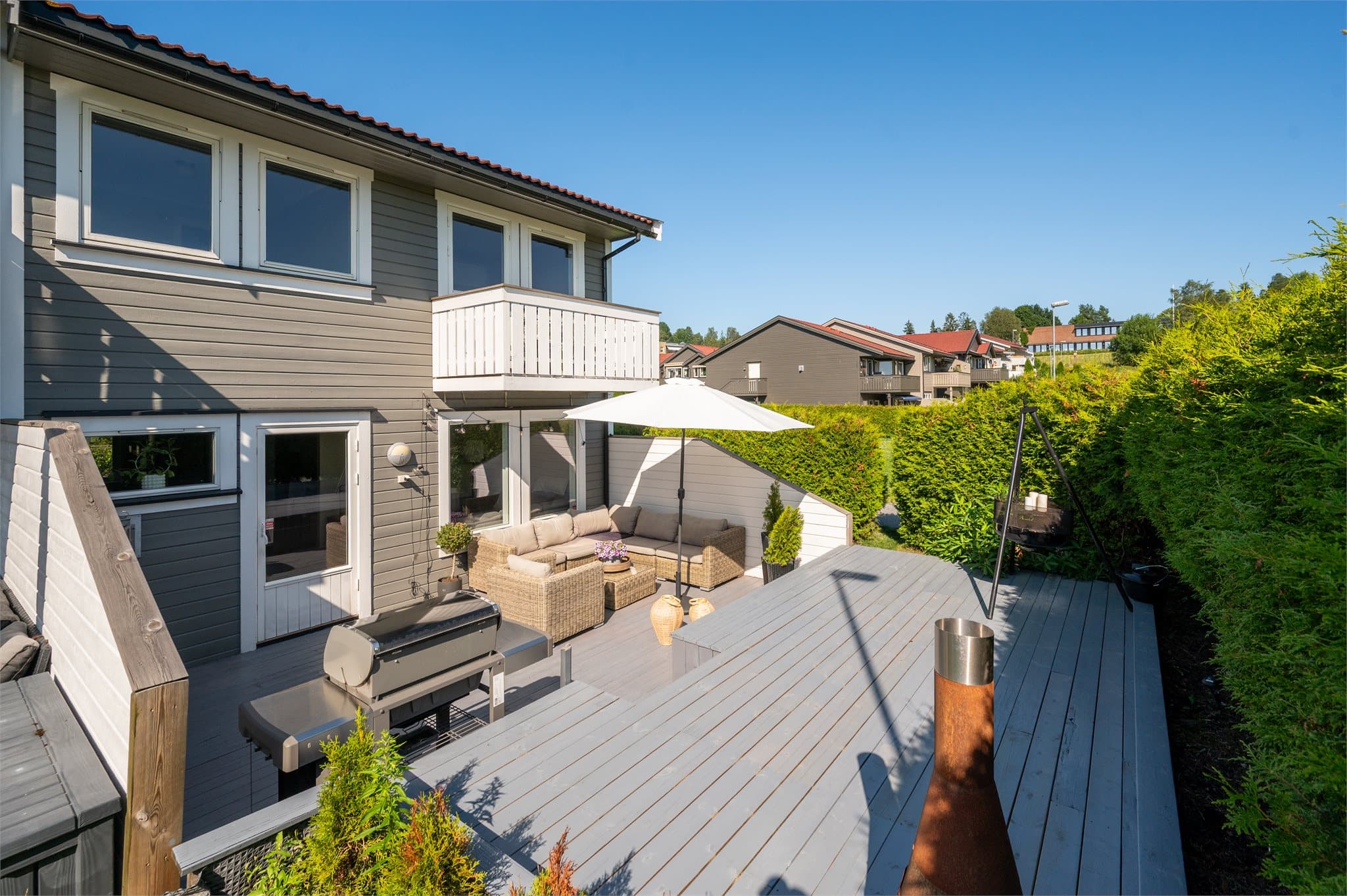 Leiligheten har en flott terrasse med høy standard, omkranset av grønt og gode solforhold.