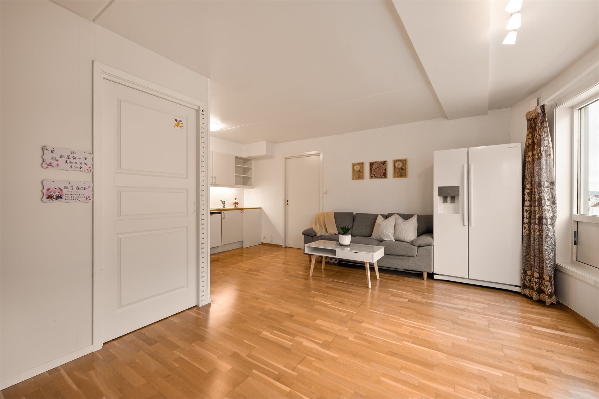 Rommet er holdt i lyse, nøytrale farger, noe som er gjennomgående for de øvrige rommene i boligen.