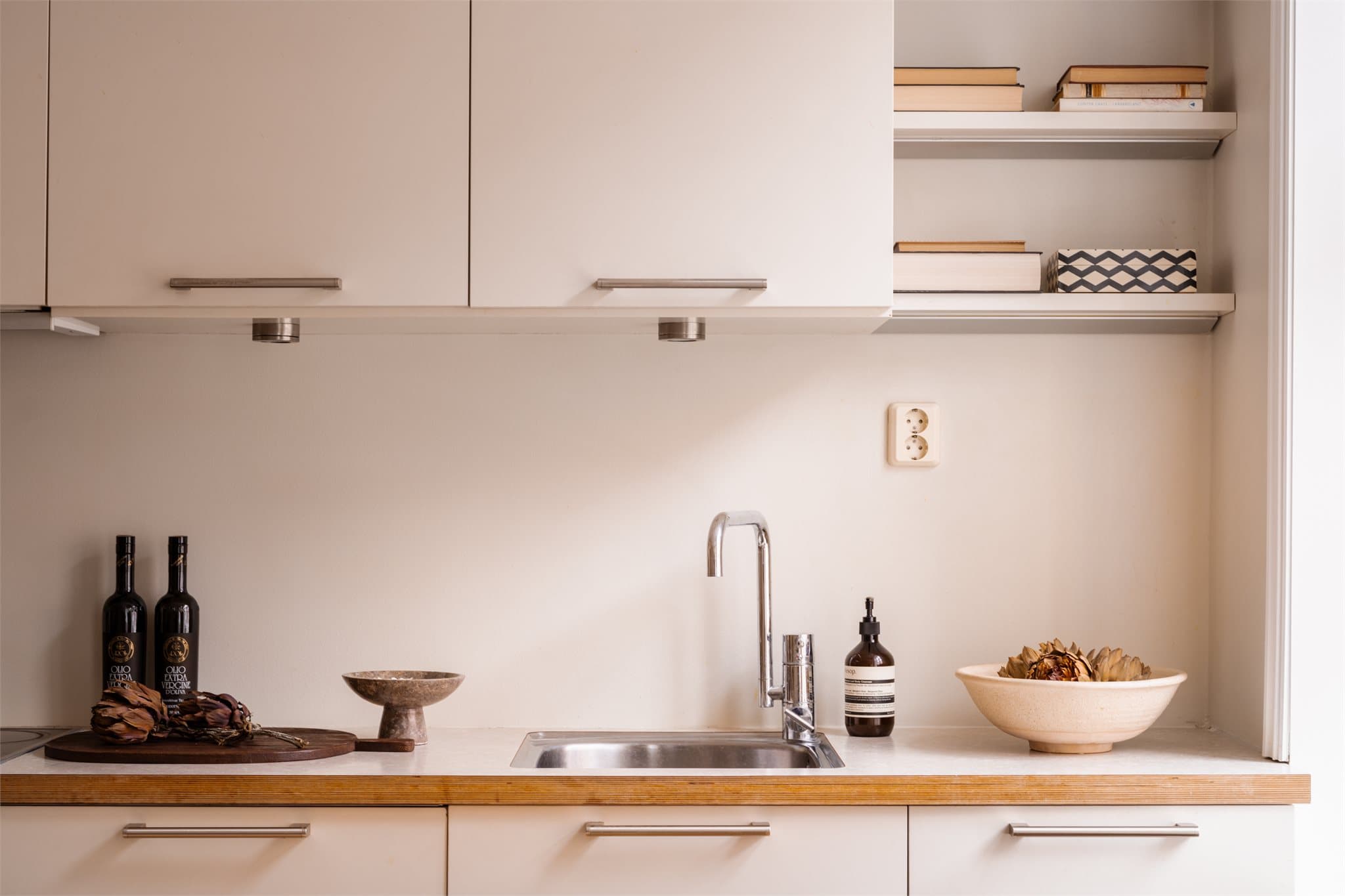 Godt med skapplass og praktiske, åpne hyller gir funksjonelle oppbevaringsløsninger på kjøkkenet.