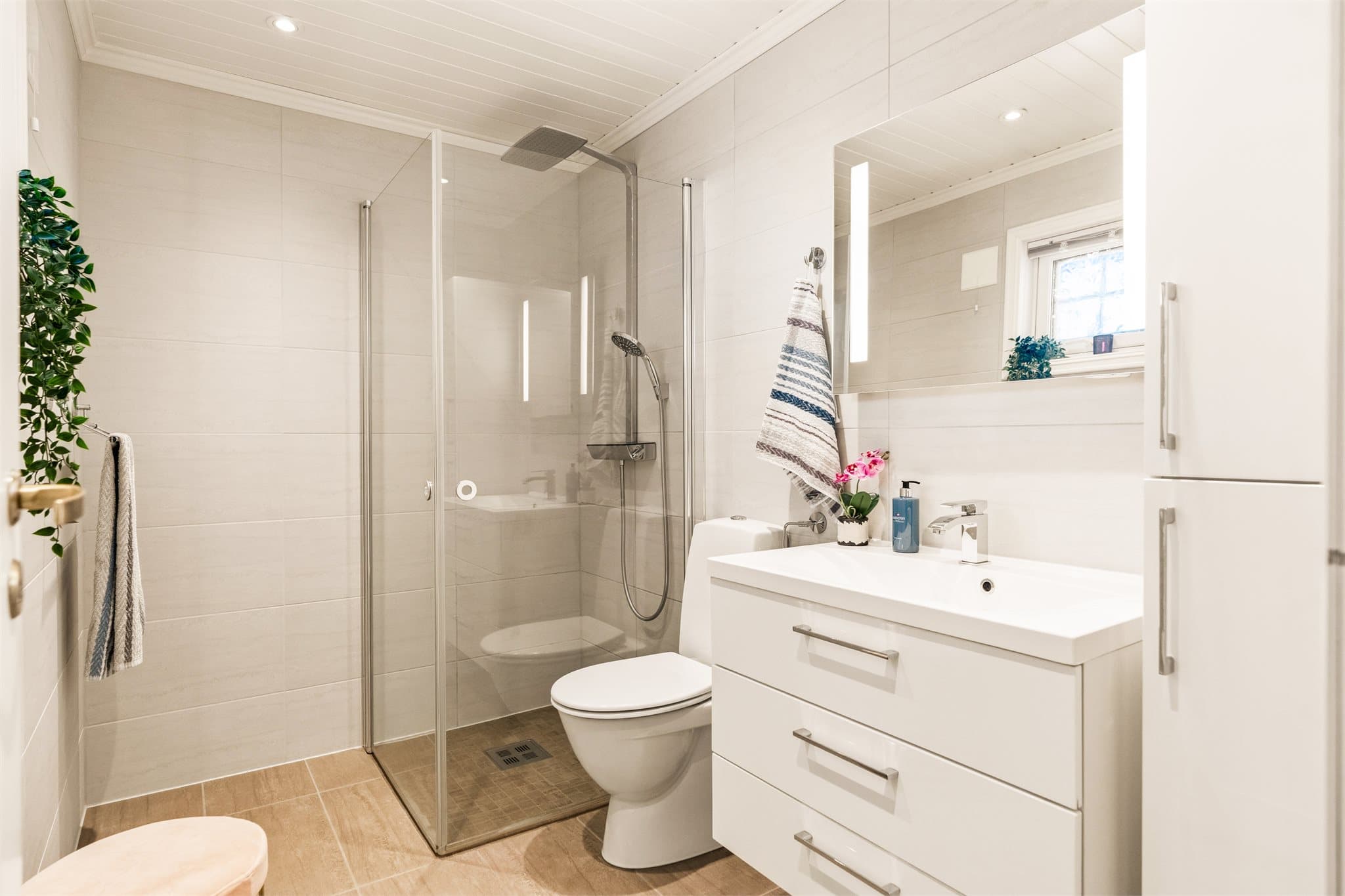 Badet har flislagt gulv med varmekabler. Downlights i himling.