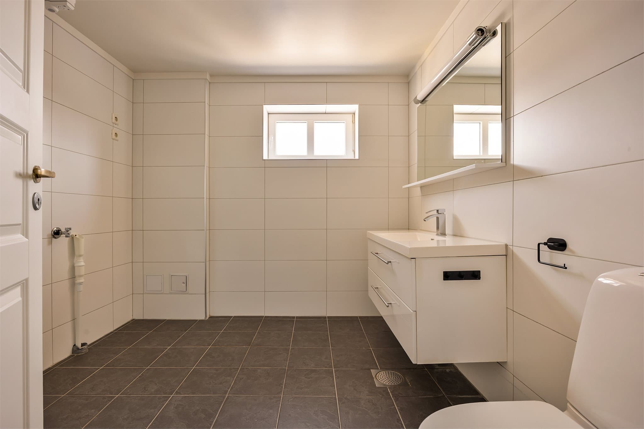 Badet har også opplegg for vaskemaskin.