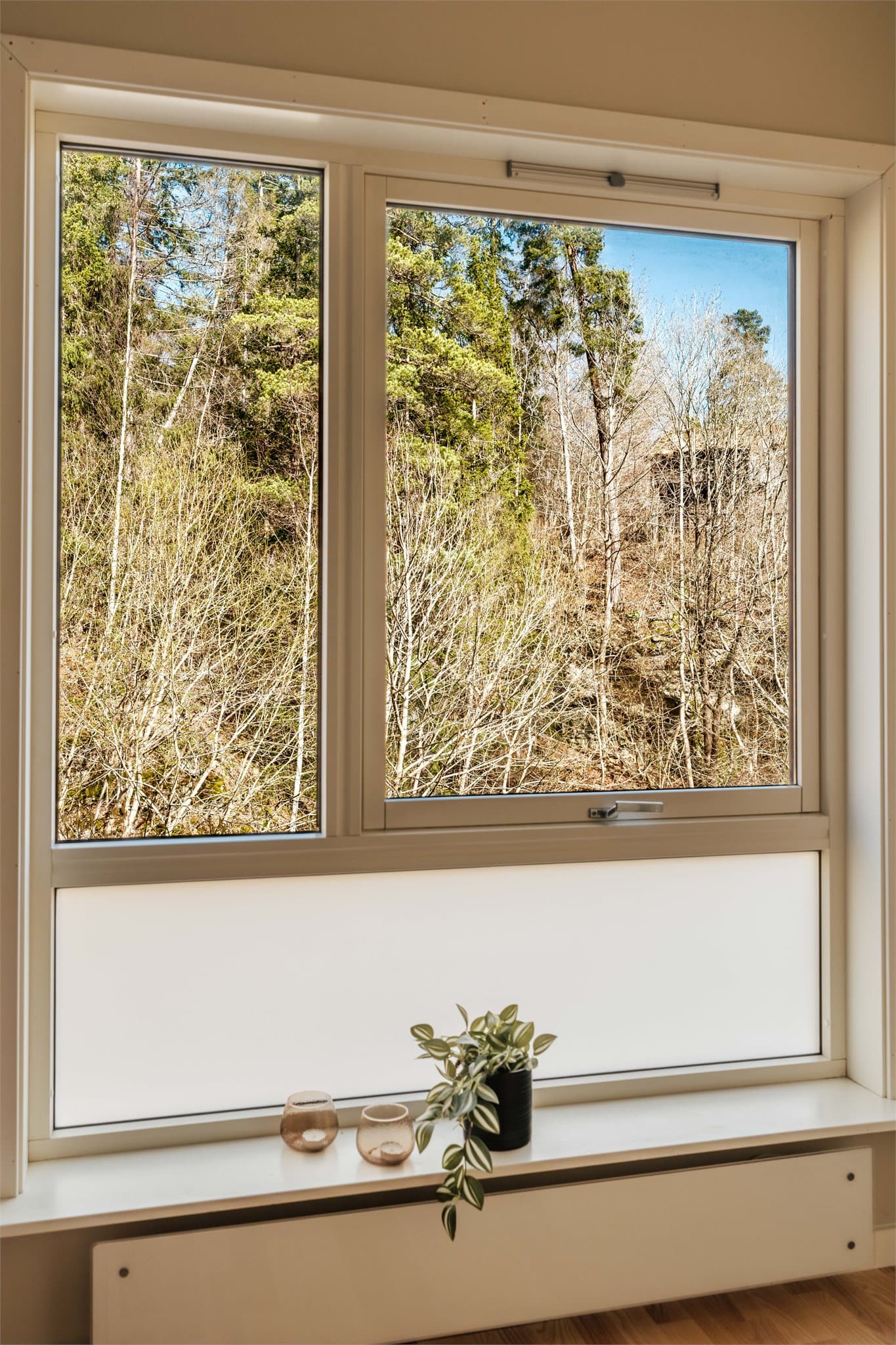 Fra vinduet er det et vakkert utsyn mot grønne omgivelser. Lyden av fossen utenfor skaper en rolig og behagelig atmosfære.