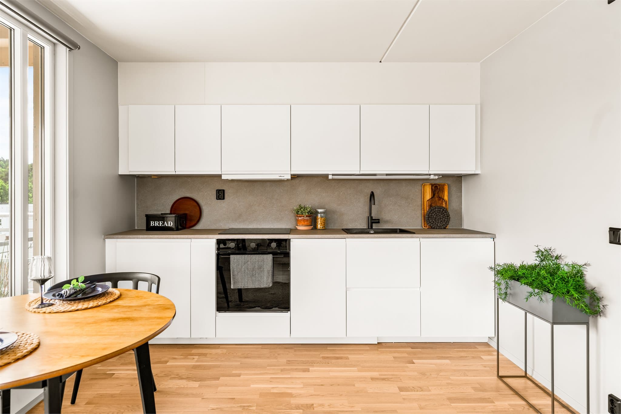 Innredningen har hvite, slette fronter og laminat benkeplate.