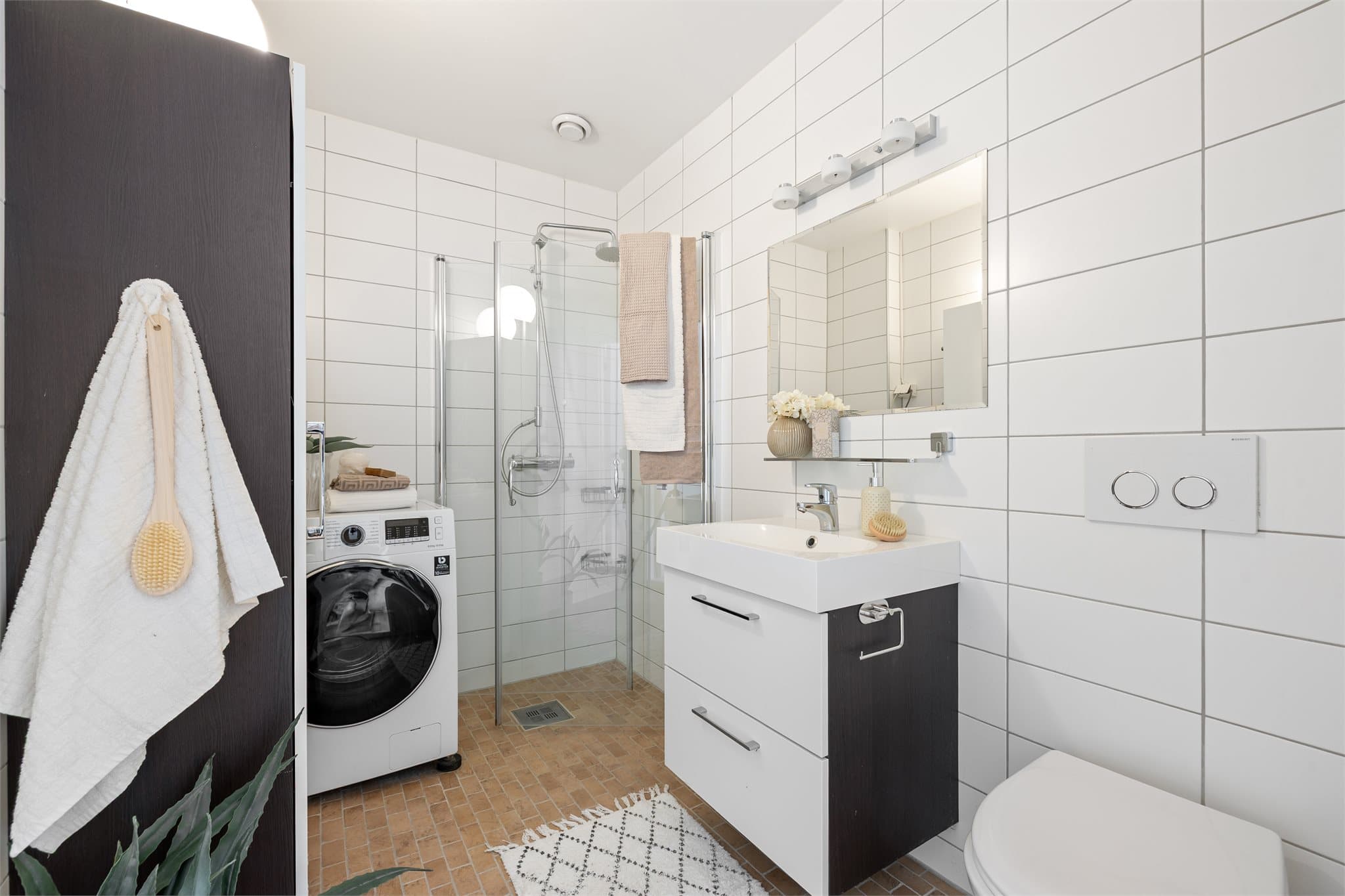 Badet er flislagt og ble oppgradert i 2010. Badet er utstyrt med dusjhjørne, toalett, vegghengt servantinnredning og opplegg for vaskemaskin.