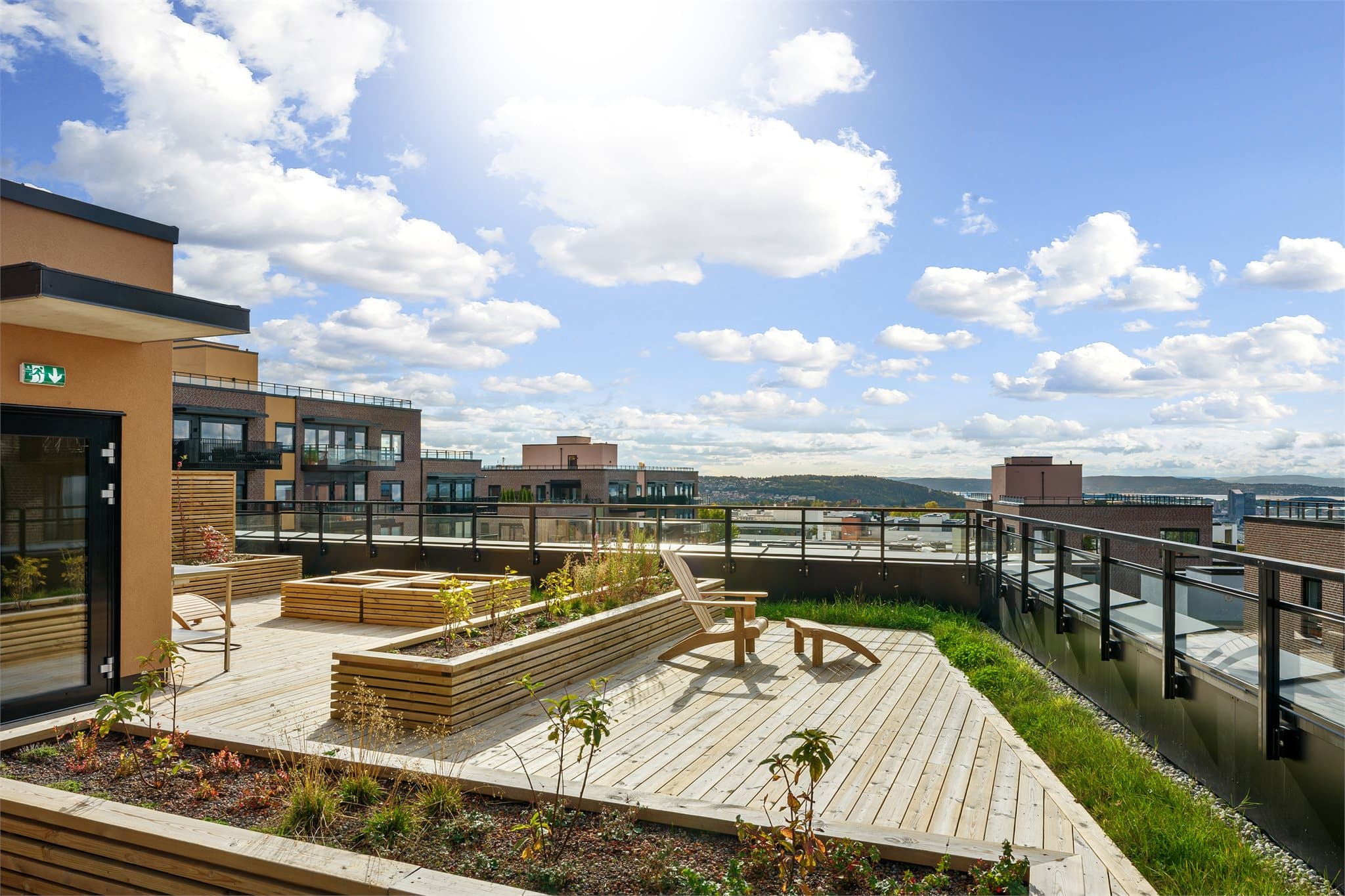 Takterrassen er pent opparbeidet med sittegrupper, plantekasser og gode solforhold.