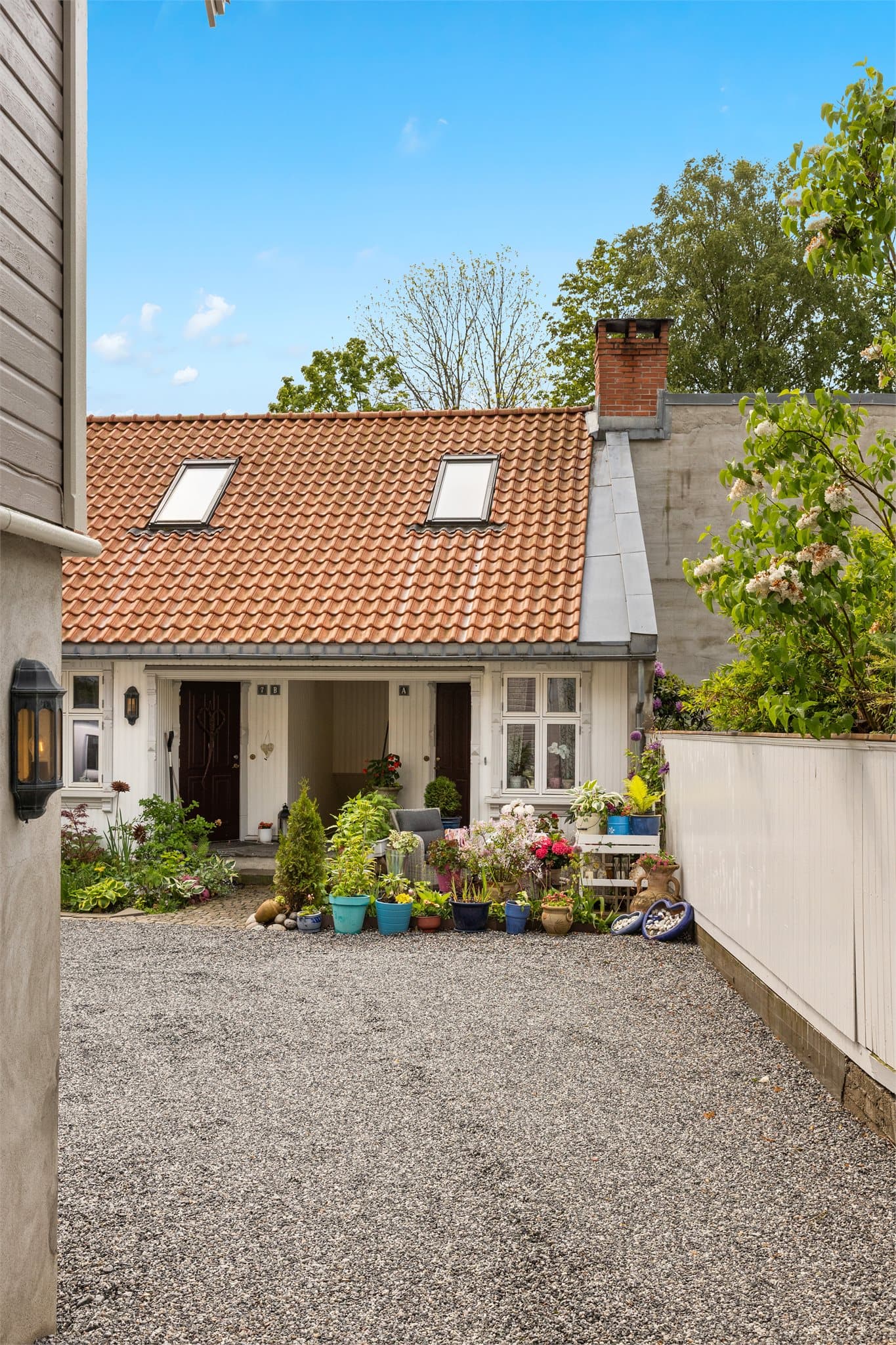 Eiendommen ligger tilbaketrukket fra gata, med adkomst via en felles gårdsplass.