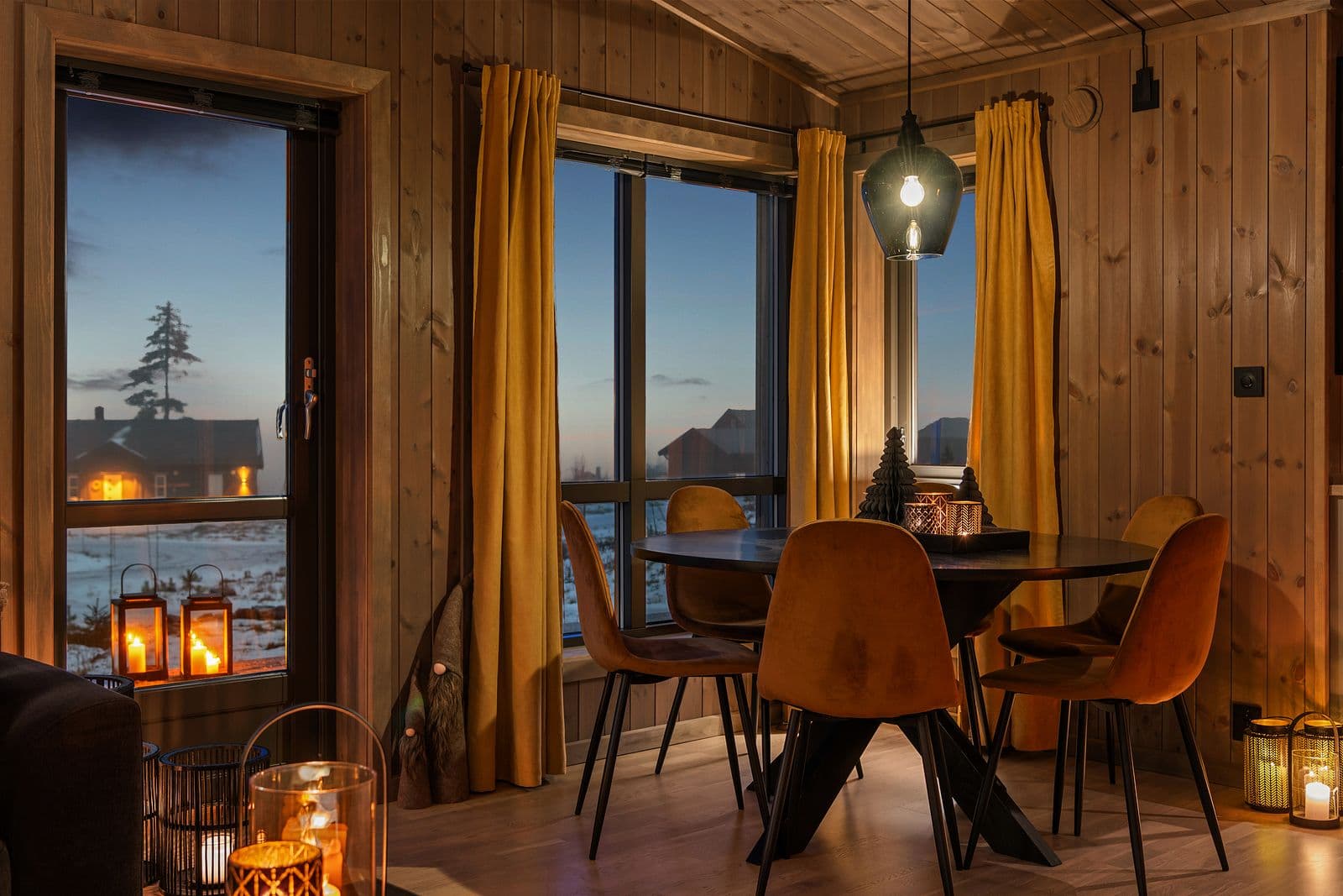 Den åpne stue- og kjøkkenløsningen gjør rommet både sosialt og praktisk, med god plass til familiemiddager, hyggelige sammenkomster og avslappende kvelder foran peisen.