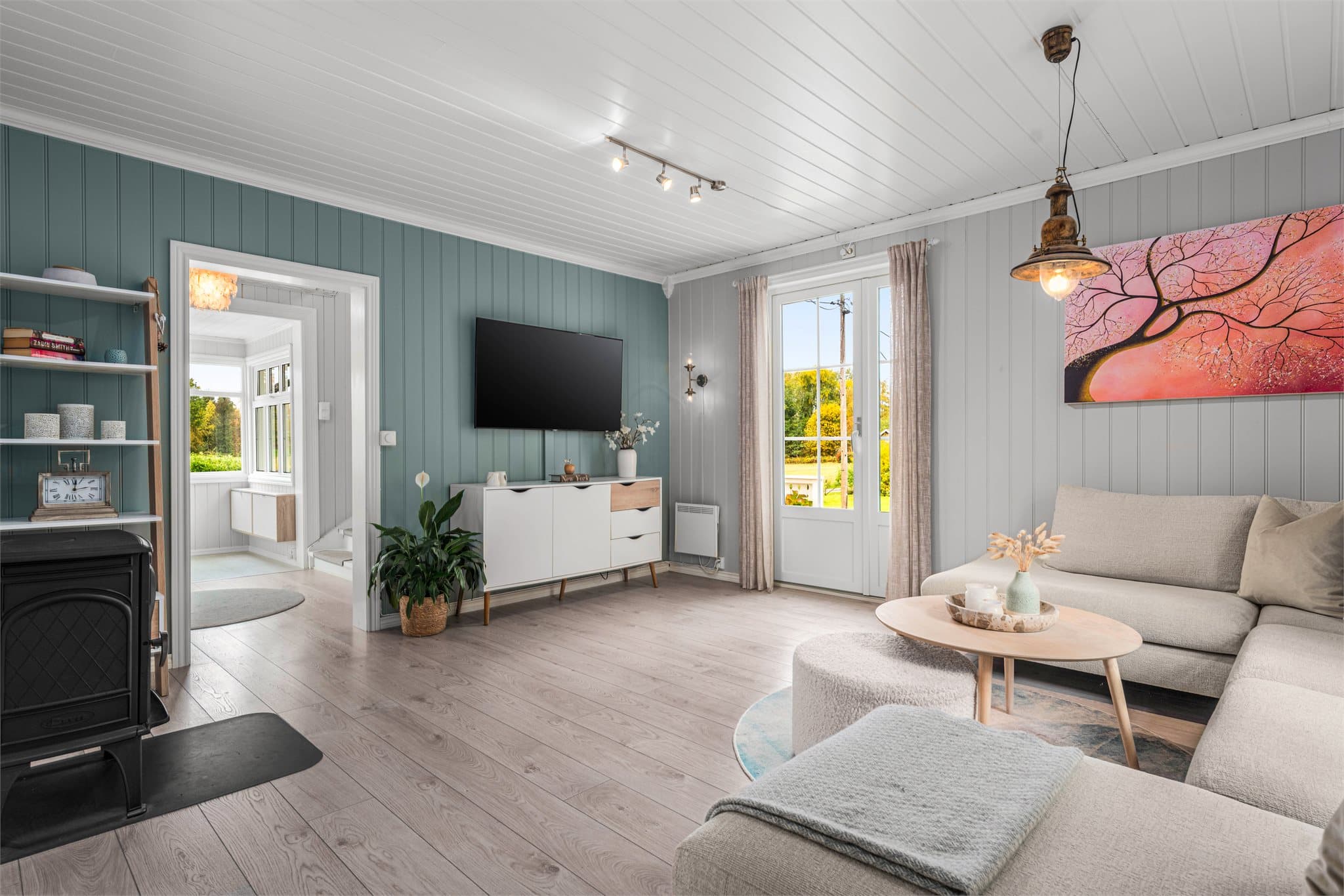 Stuen har malte panelvegger og direkte utgang til terrassen