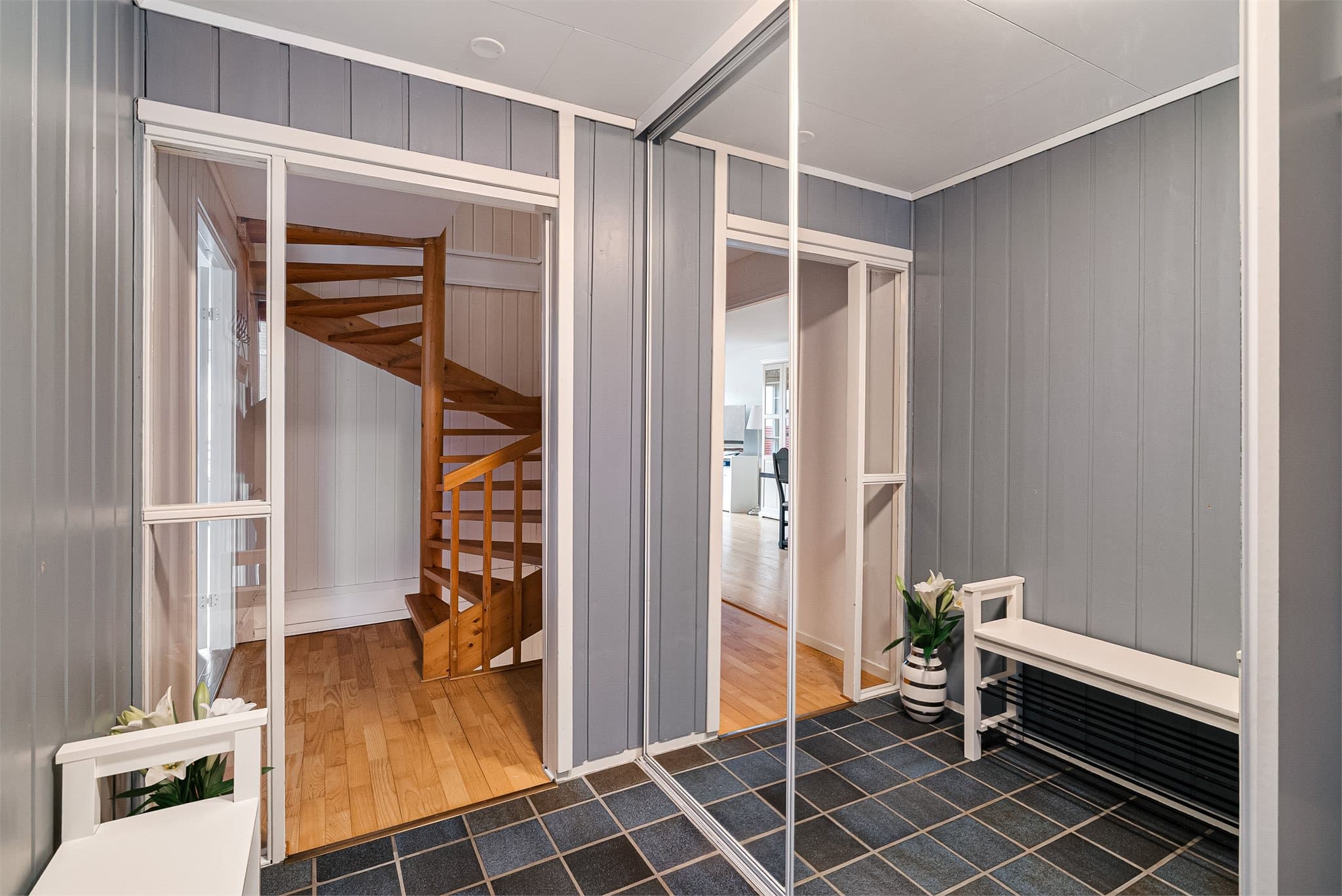 Lys og innbydende entré med garderobeløsning og adkomst til både hovedetasje og kjeller.