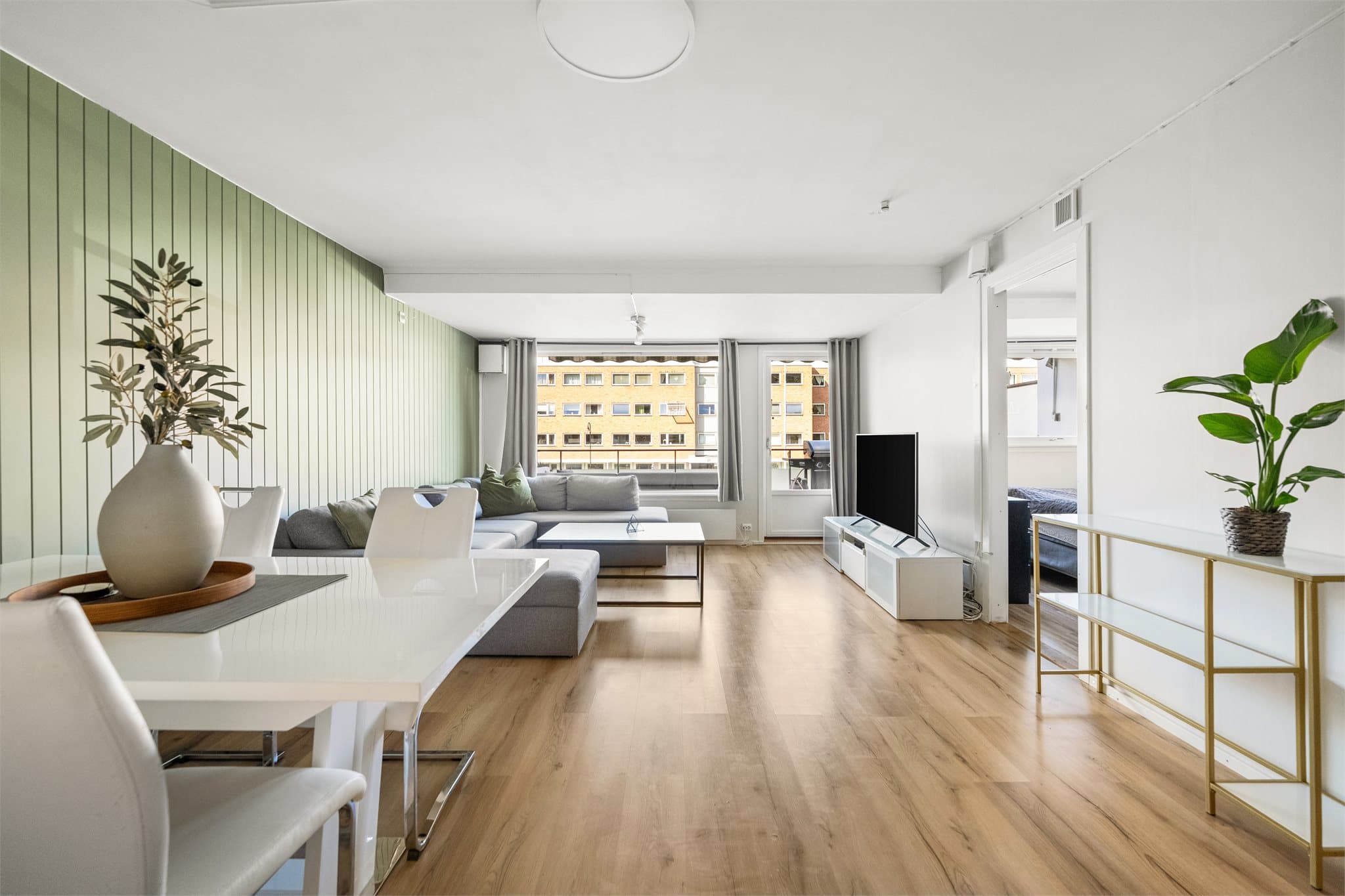 Lys og romslig stue med store vindusflater som slipper inn rikelig med naturlig lys. Her er det naturlige soner for både sofa- og spisegruppe.