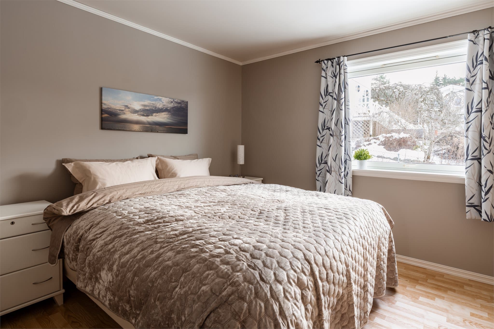 Et romslig hovedsoverom med plass til dobbeltseng og nattbord.