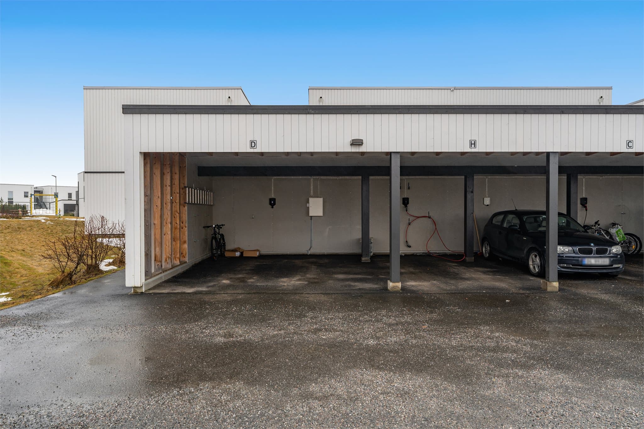 Stor carport på enden med elbillader.