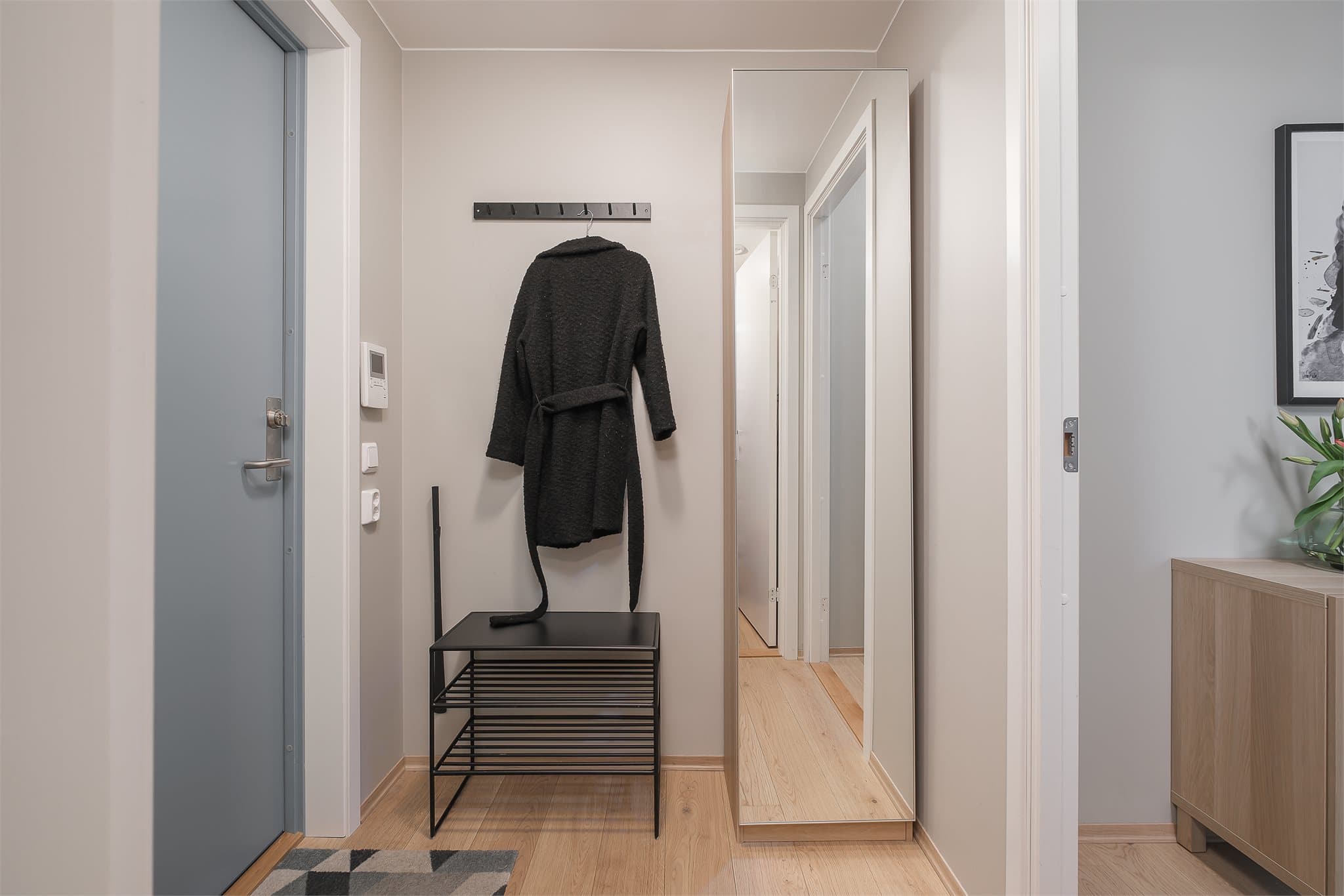 Lys og innbydende entré med god plass til oppbevaring av yttertøy og sko. En praktisk velkomstsone som gir et godt førsteinntrykk av boligen.