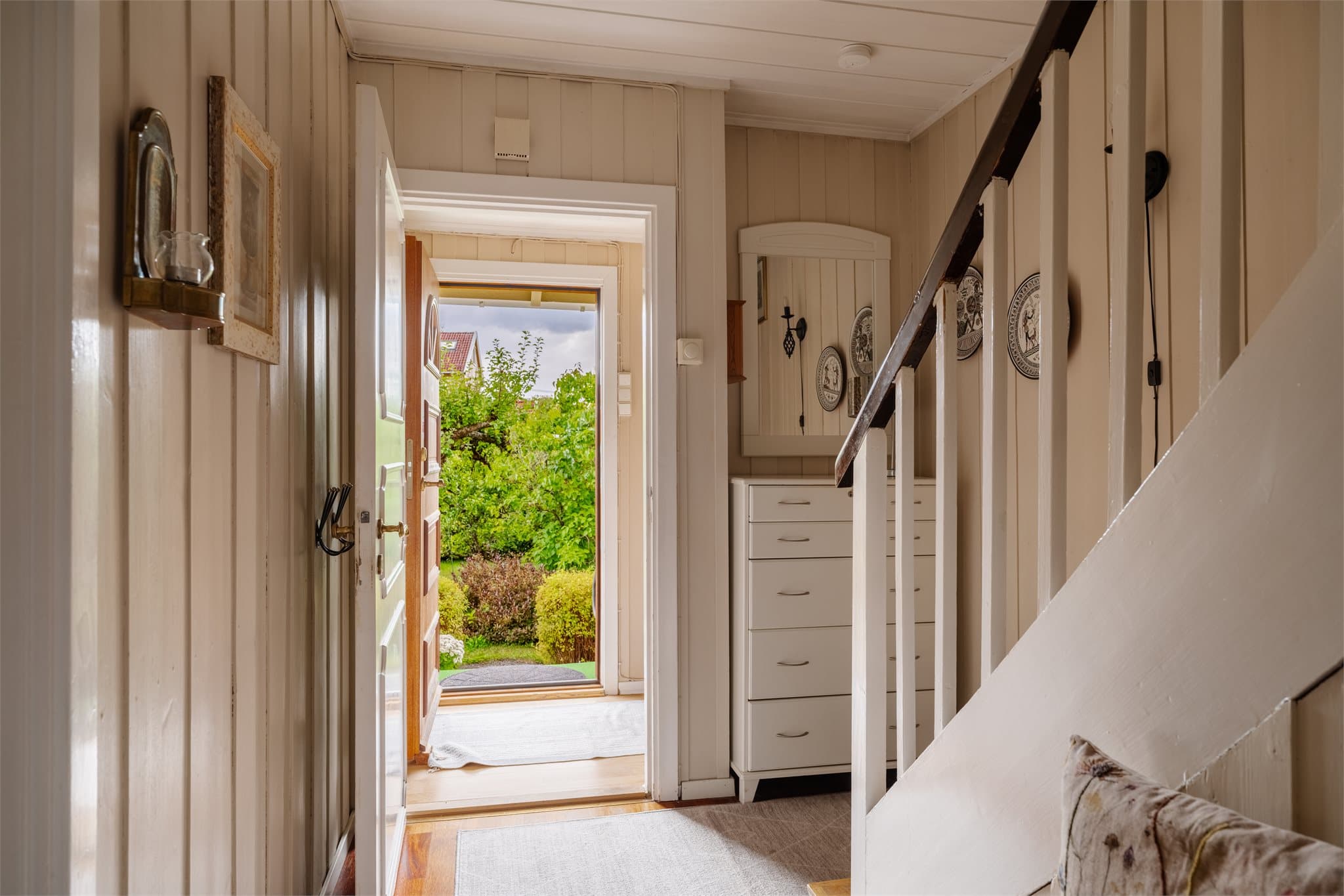 Entré med adkomst til hall og trapp til de øvrige etasjene. Ytterdøren er i teak.