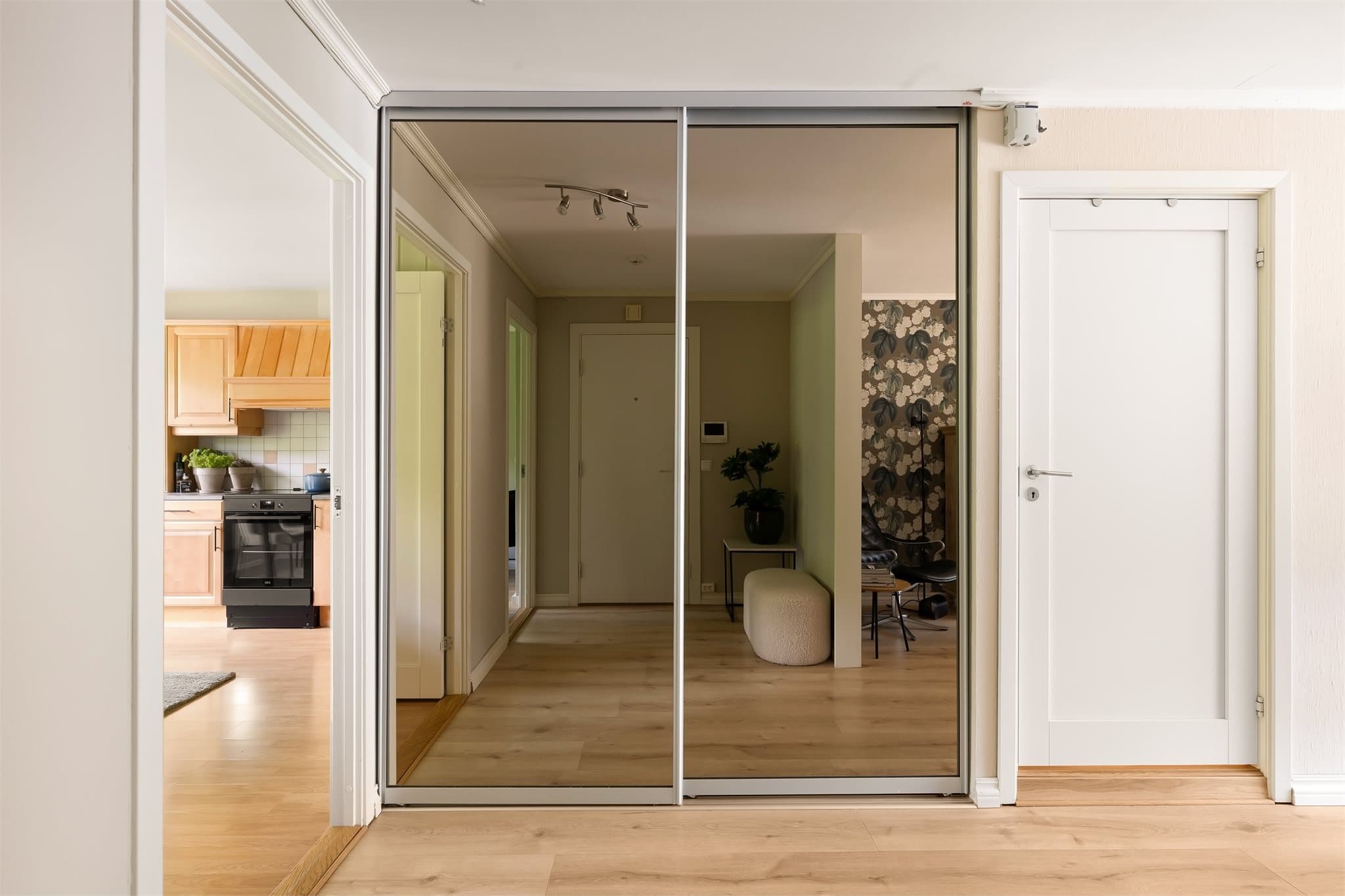 Praktisk skyvedørsgarderobe med speil i entréen gir god plass til yttertøy.