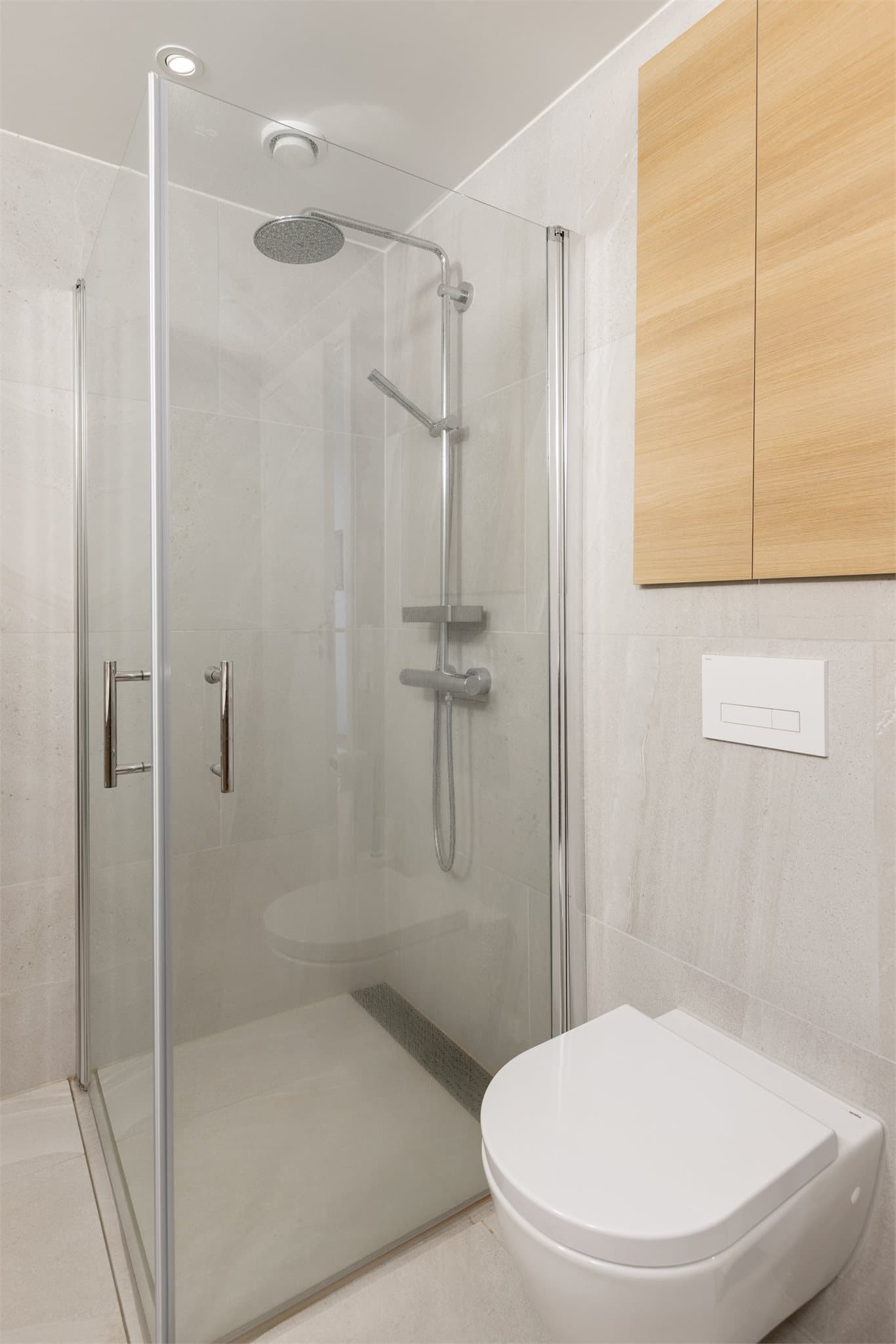 Badet har store lekre fliser i lys utførsel både på vegger og gulv.