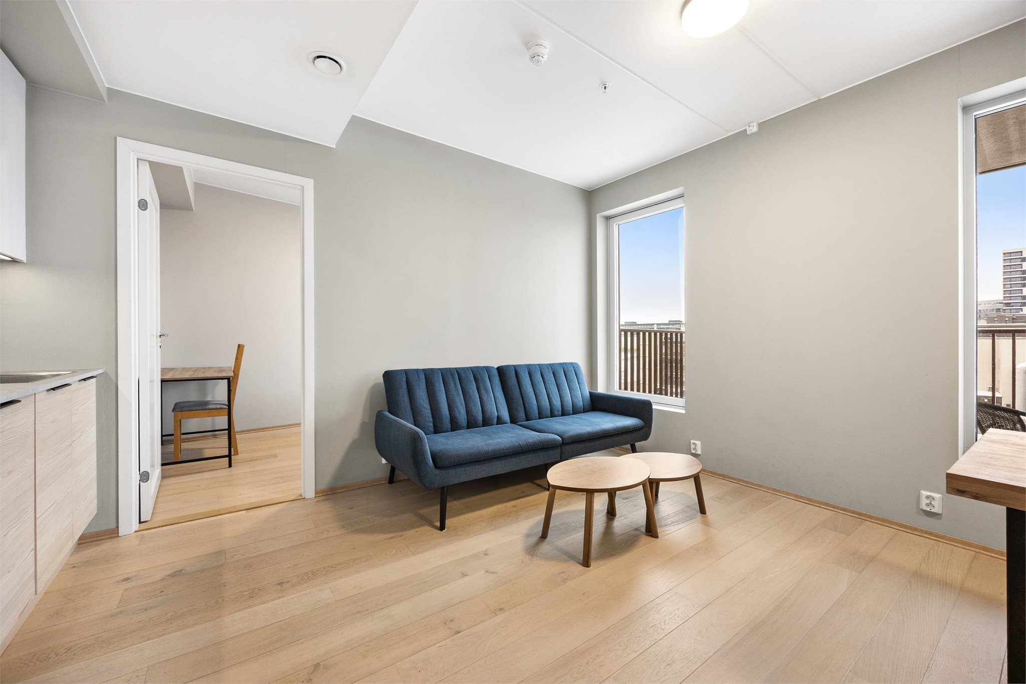 Stuen er malt i en lys og tidsriktig fargetone komplimentert med et pent parkettgulv.