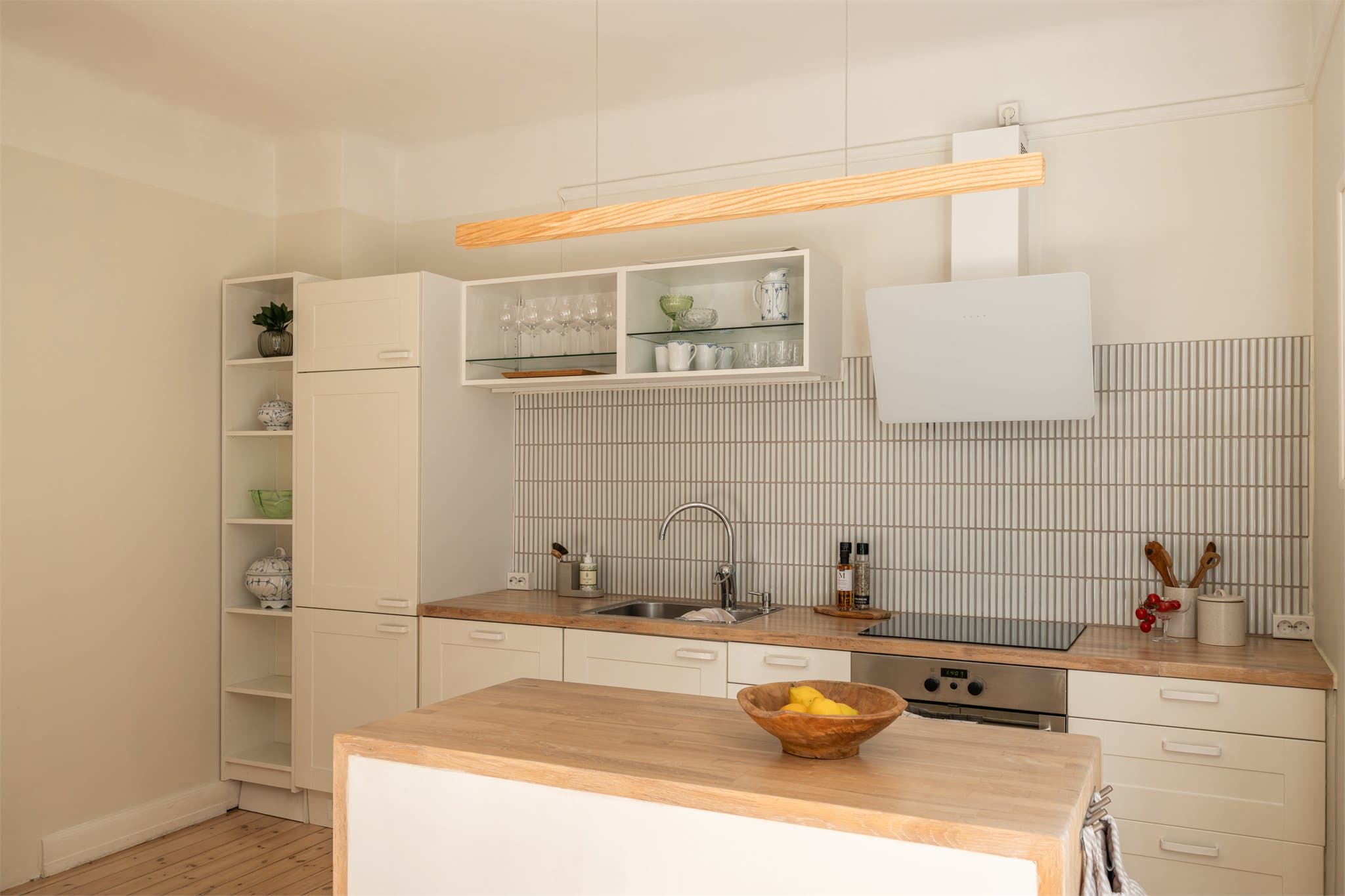 Det er lagt inn stemningsbelysning over kjøkkenøyen og under overskapene som gir en hyggelig atmosfære på kveldstid.