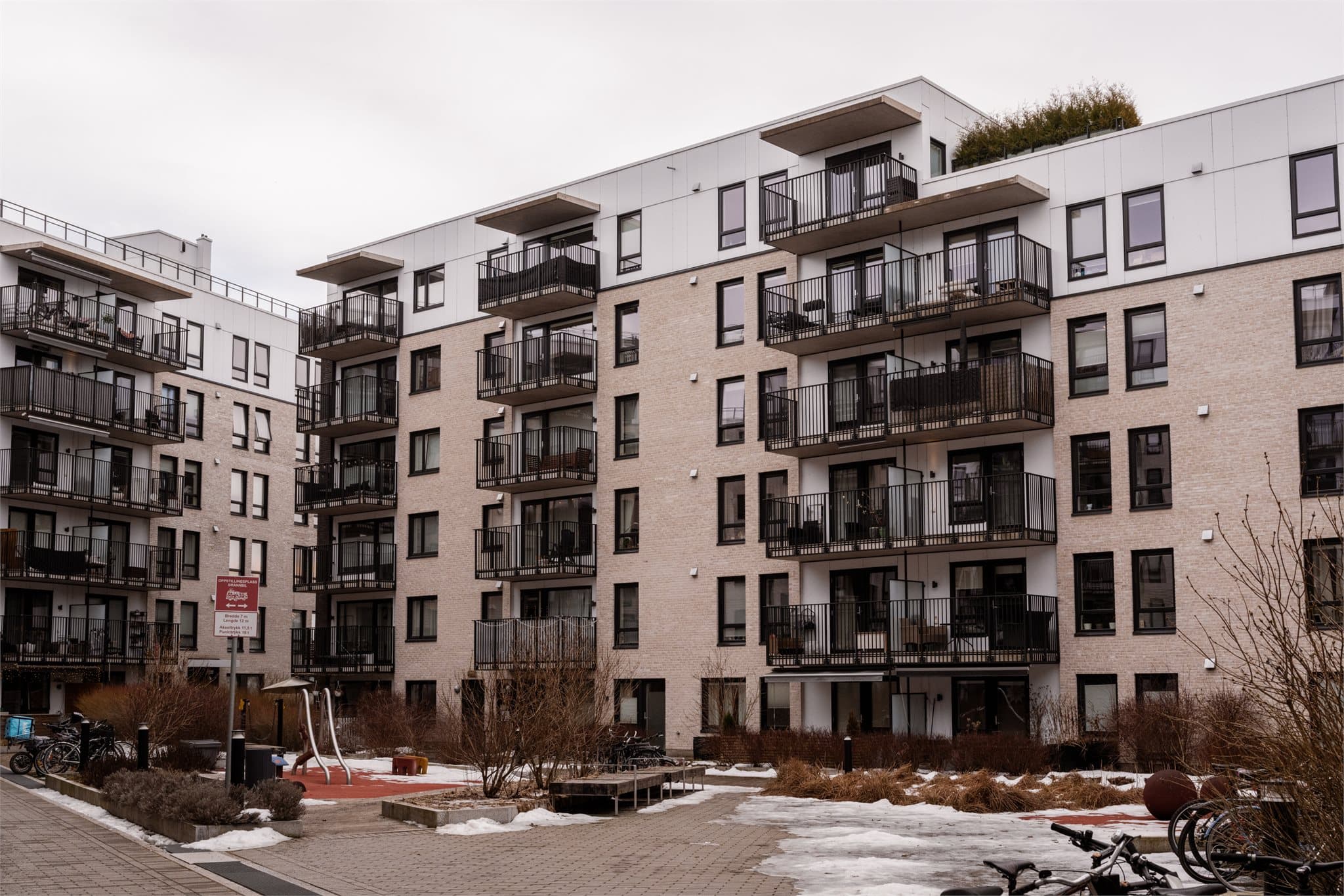 Hyggelig, bilfritt gårdsrom med lekeplass, sittegrupper og sykkelparkering – et fint fellesområde for både store og små.