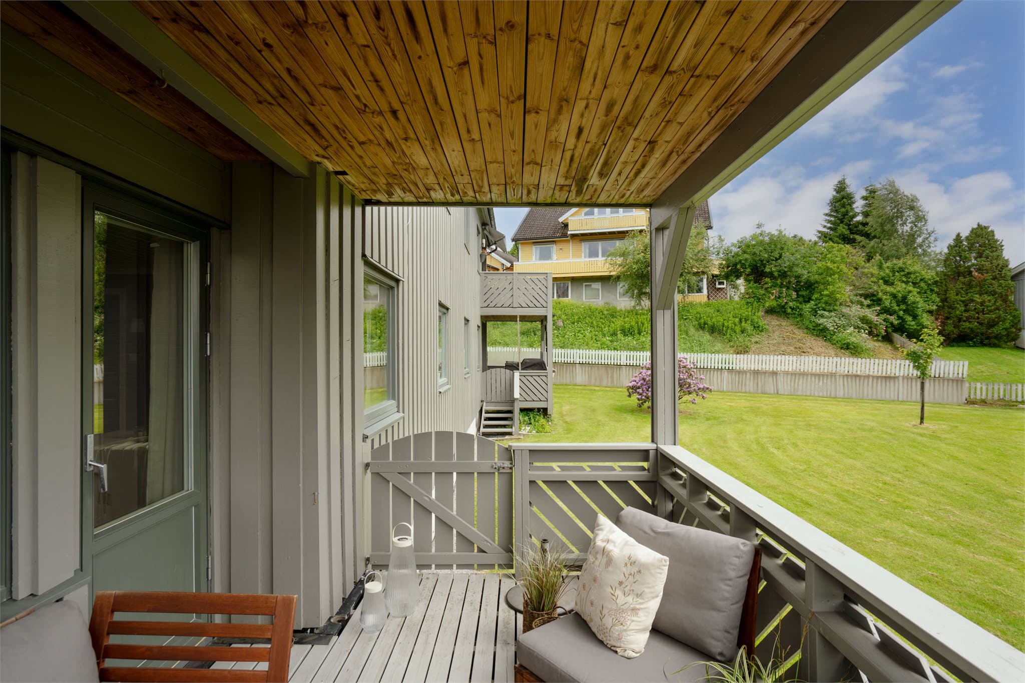 Verandaen har trapp ned til de store, felles gressarealene.