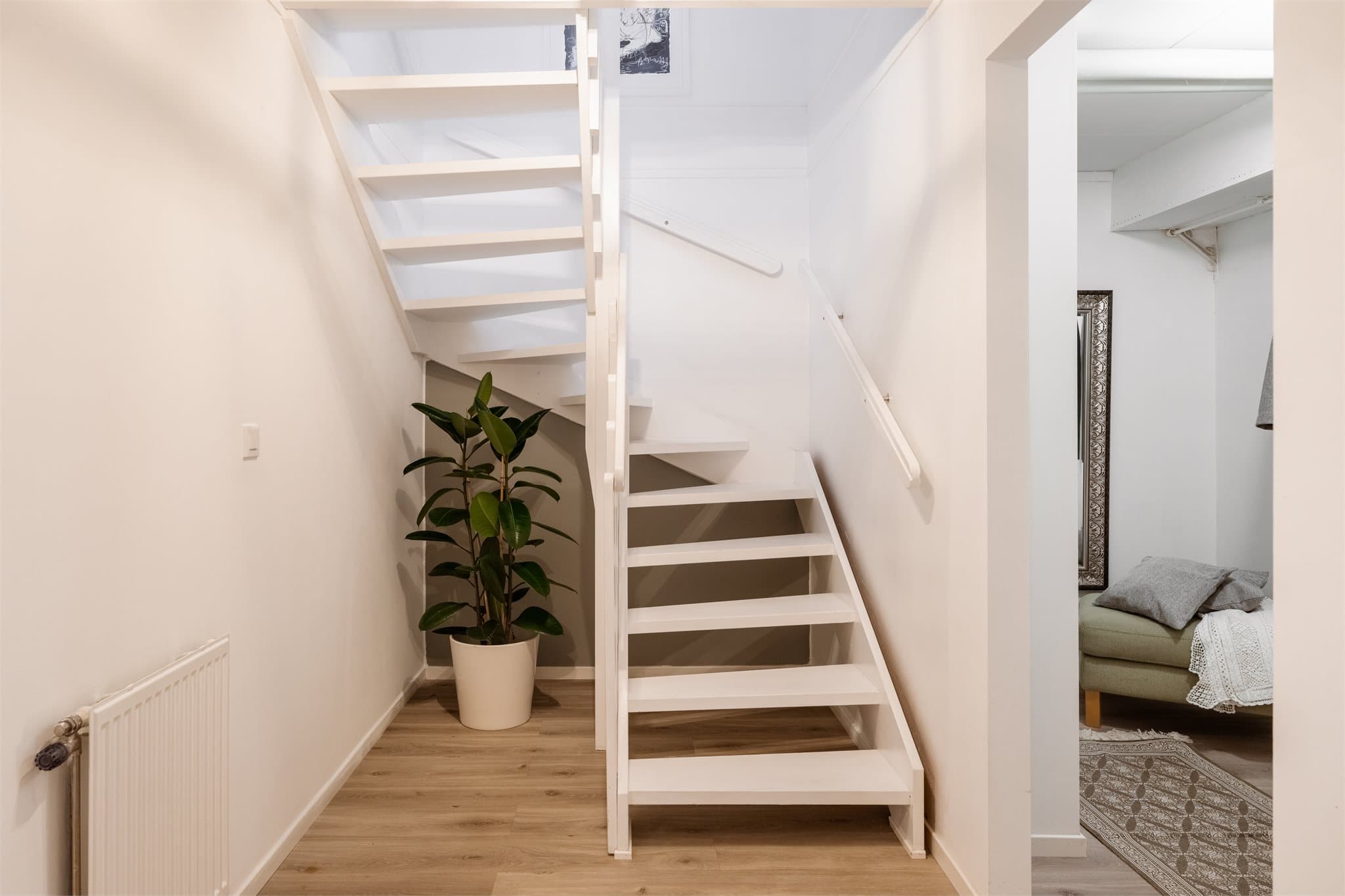 Den malte svingtrappen leder deg videre opp til boligens sosiale hovedetasje.