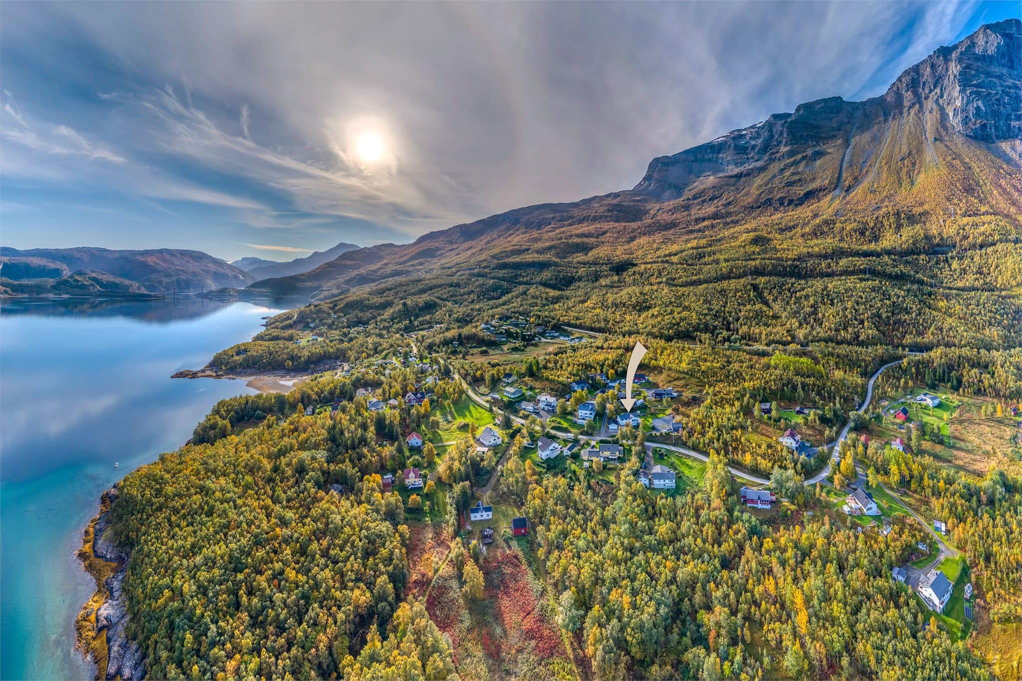 Naturskjønne omgivelser med åpen utsikt over fjordarmen og fjellene omkring.