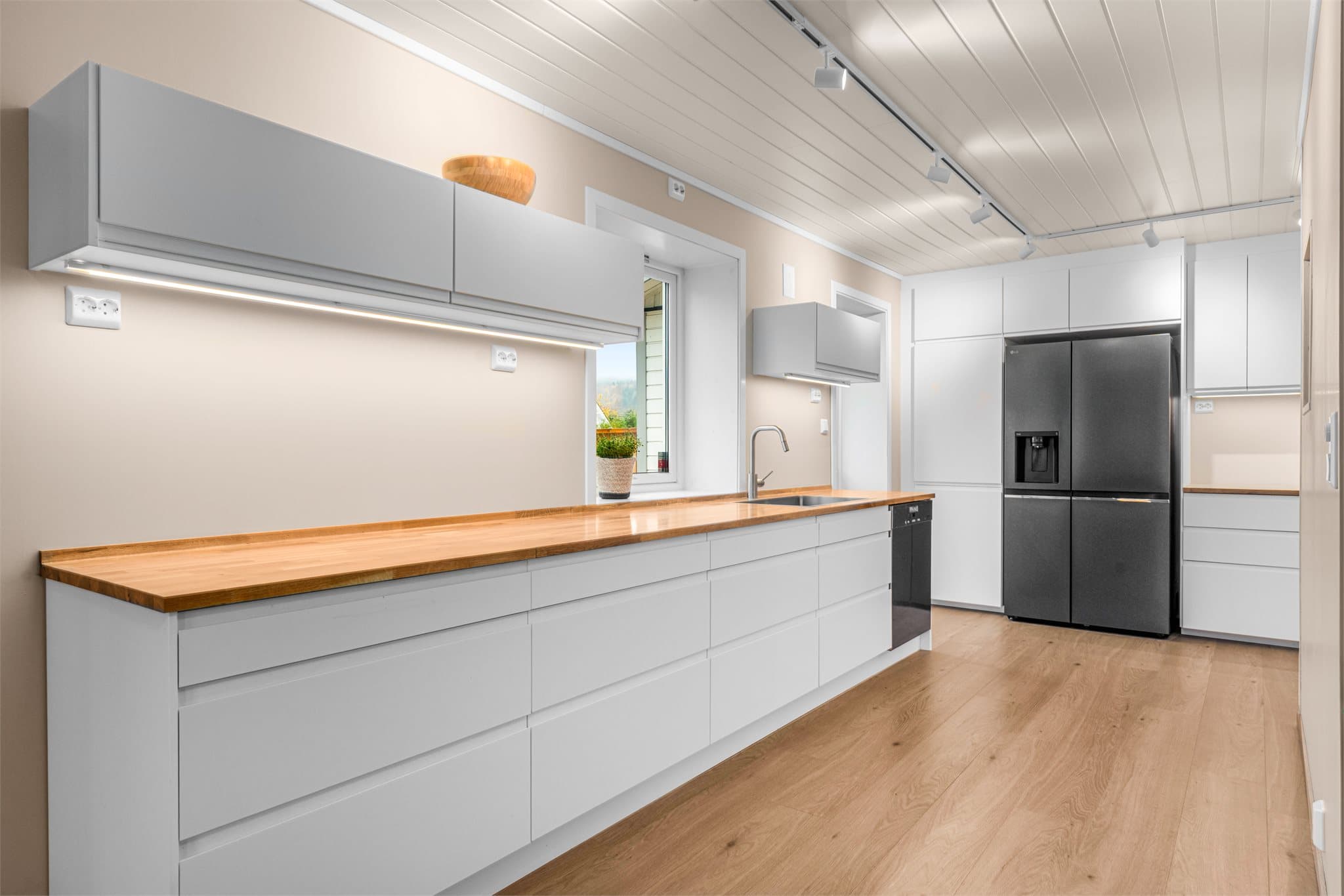 Det er satt inn ny kjøkkeninnredning fra Ikea med hvite, slette fronter og heltre benkeplate.