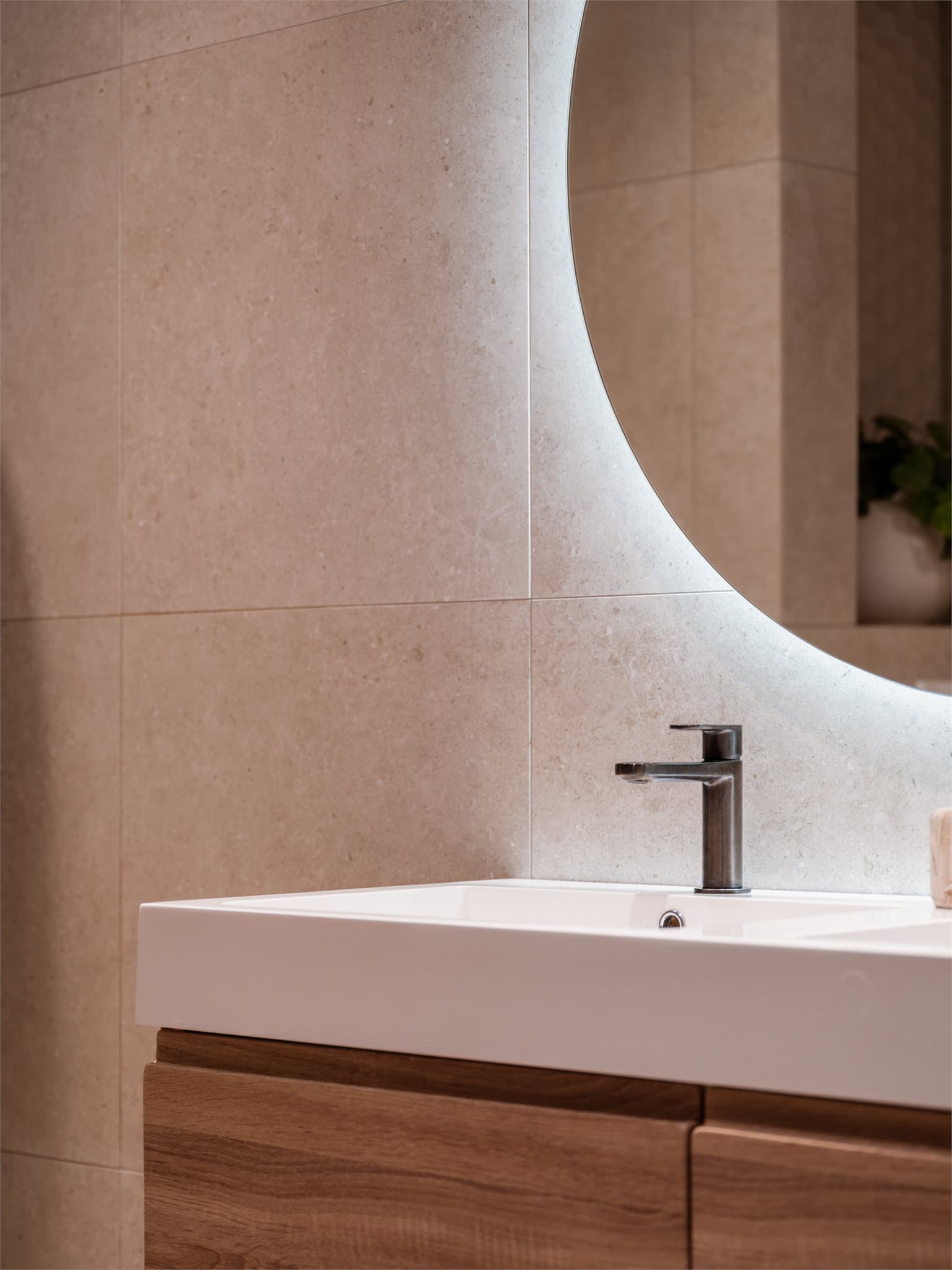 Romslig innredning med dobbel servant og speil med integrert belysning.