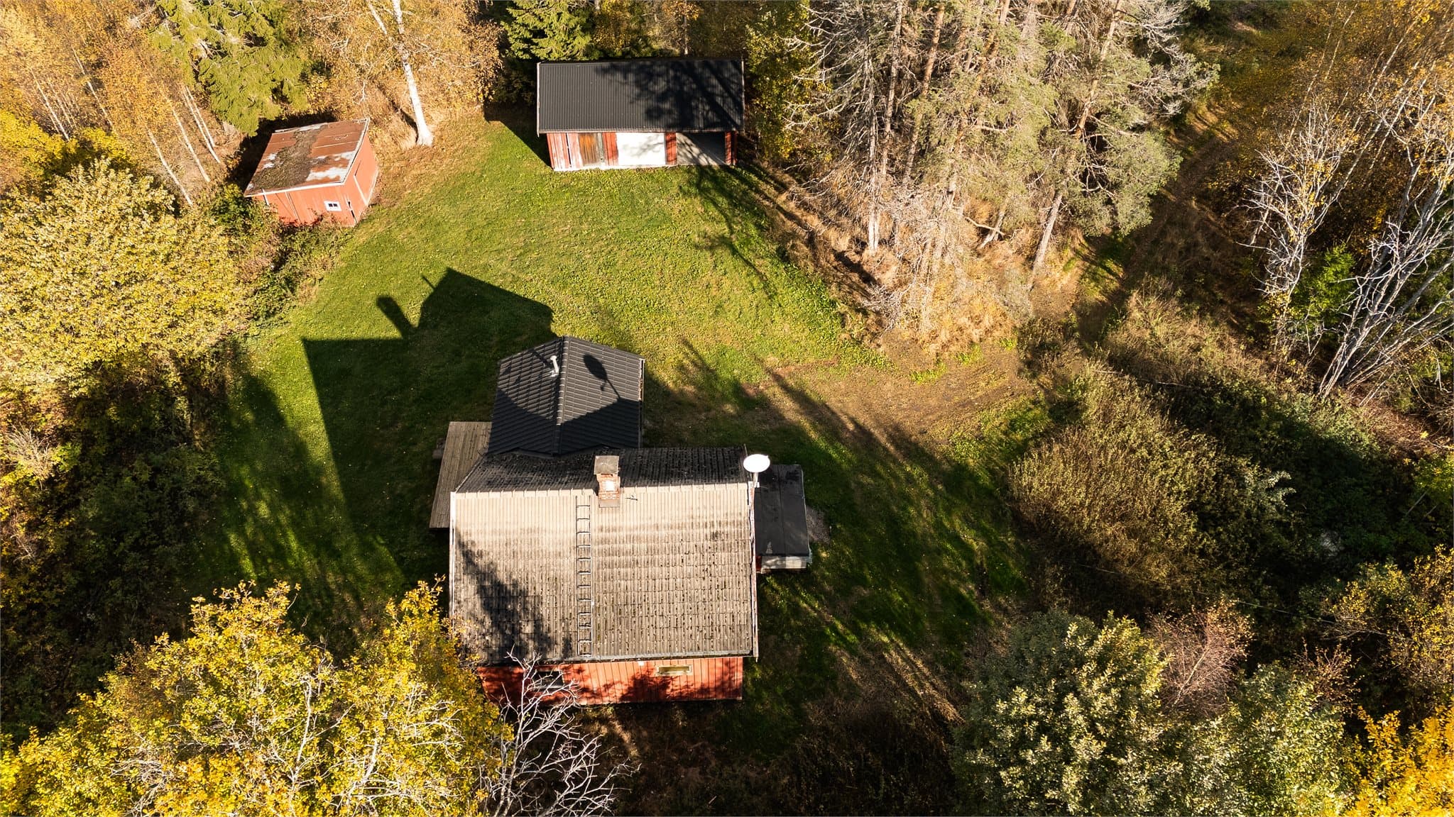 Den åpne hageplassen ligger fint til mellom boligen og de øvrige bygningene.