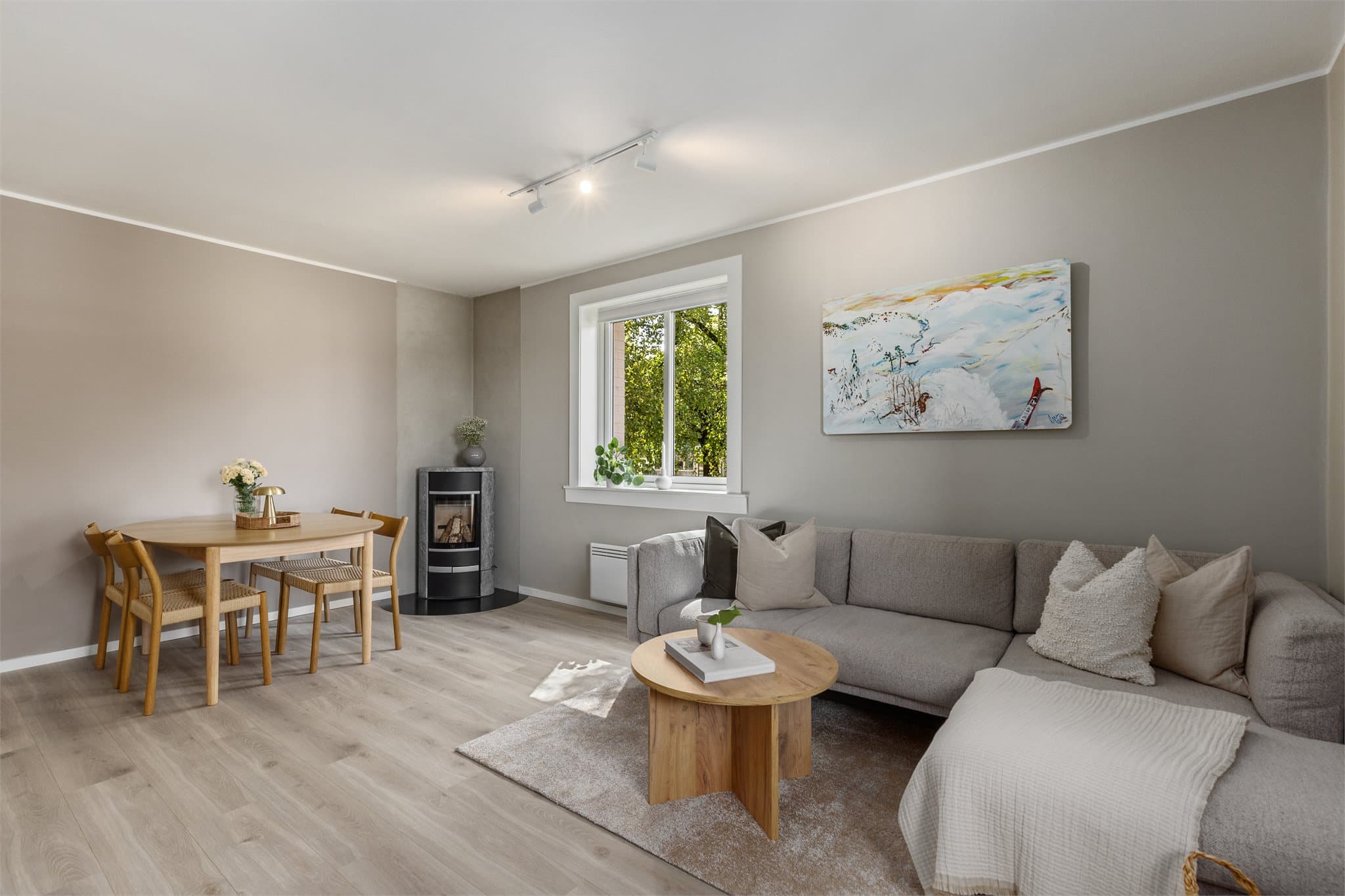 Stuen er hjemmets naturlige samlingspunkt, med store vindusflater som slipper inn rikelig med lys og fremhever rommets luftighet