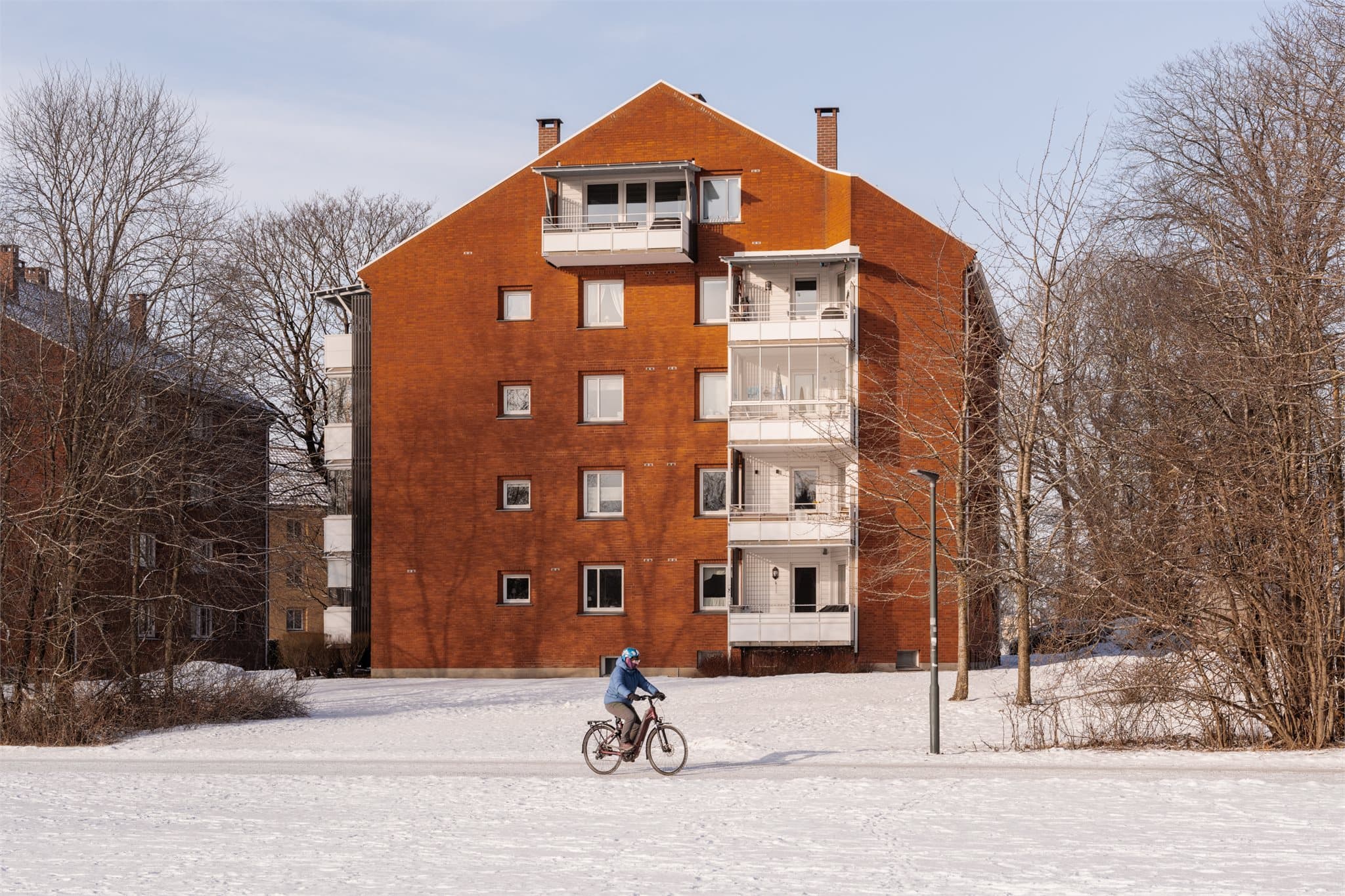 Bygget har en klassisk fasade i spekkmurt teglstein og ligger fint til i terrenget.