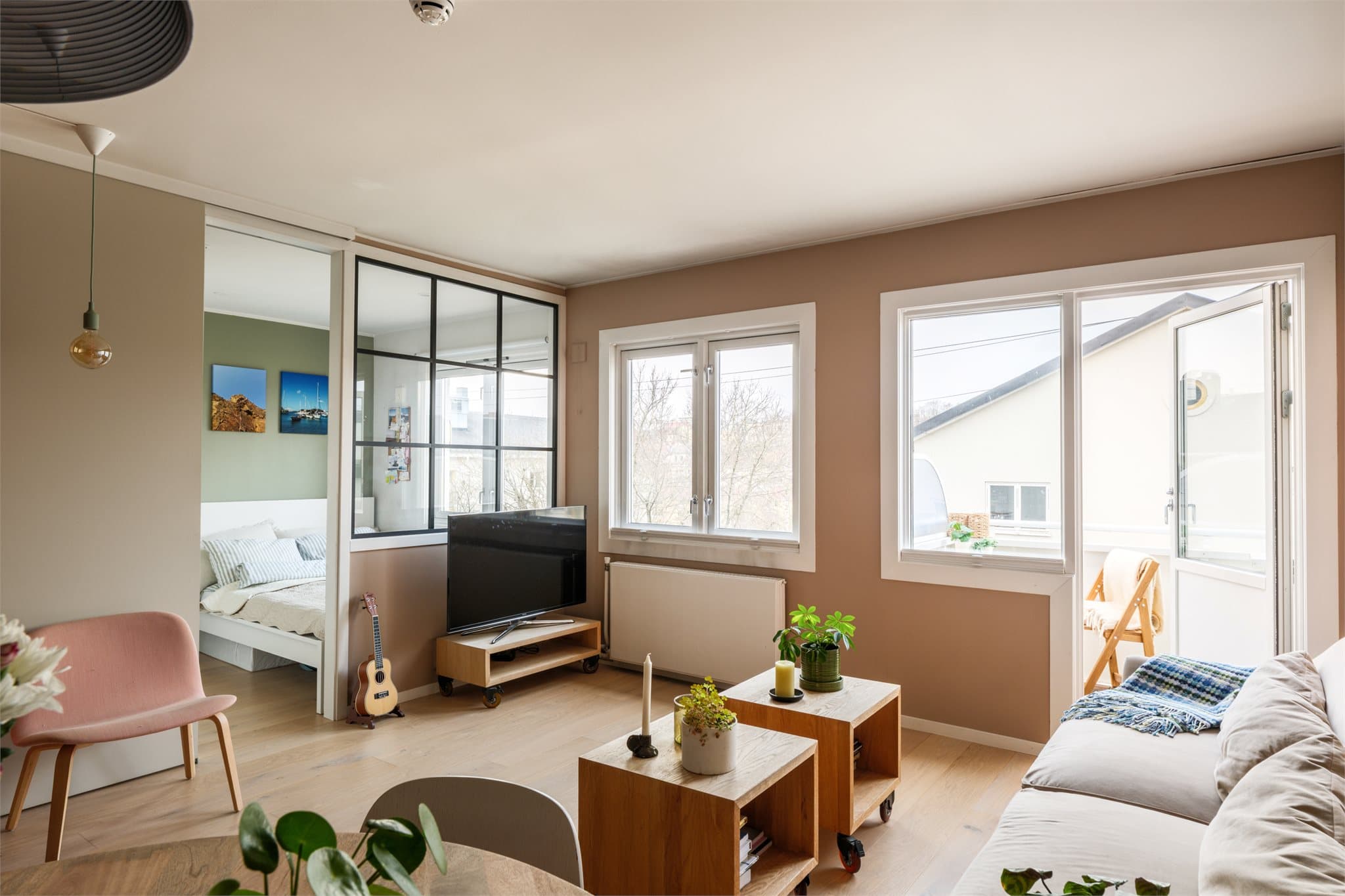 Store vindusflater og utgang til balkong gir rikelig med naturlig lys.