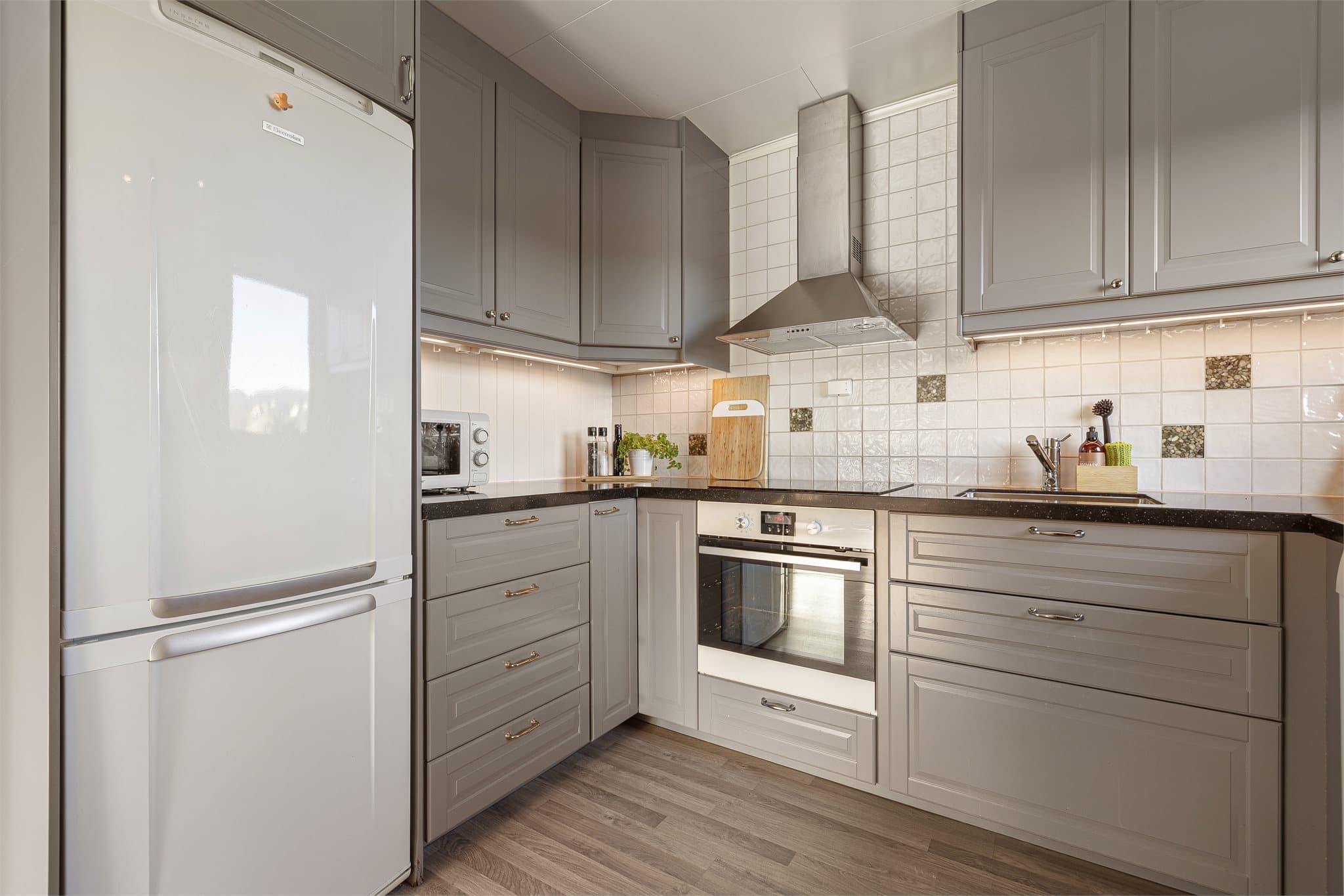 Kjøkkenet er godt utstyrt med rikelig skap- og skuffeplass samt gode benkeoverflater.