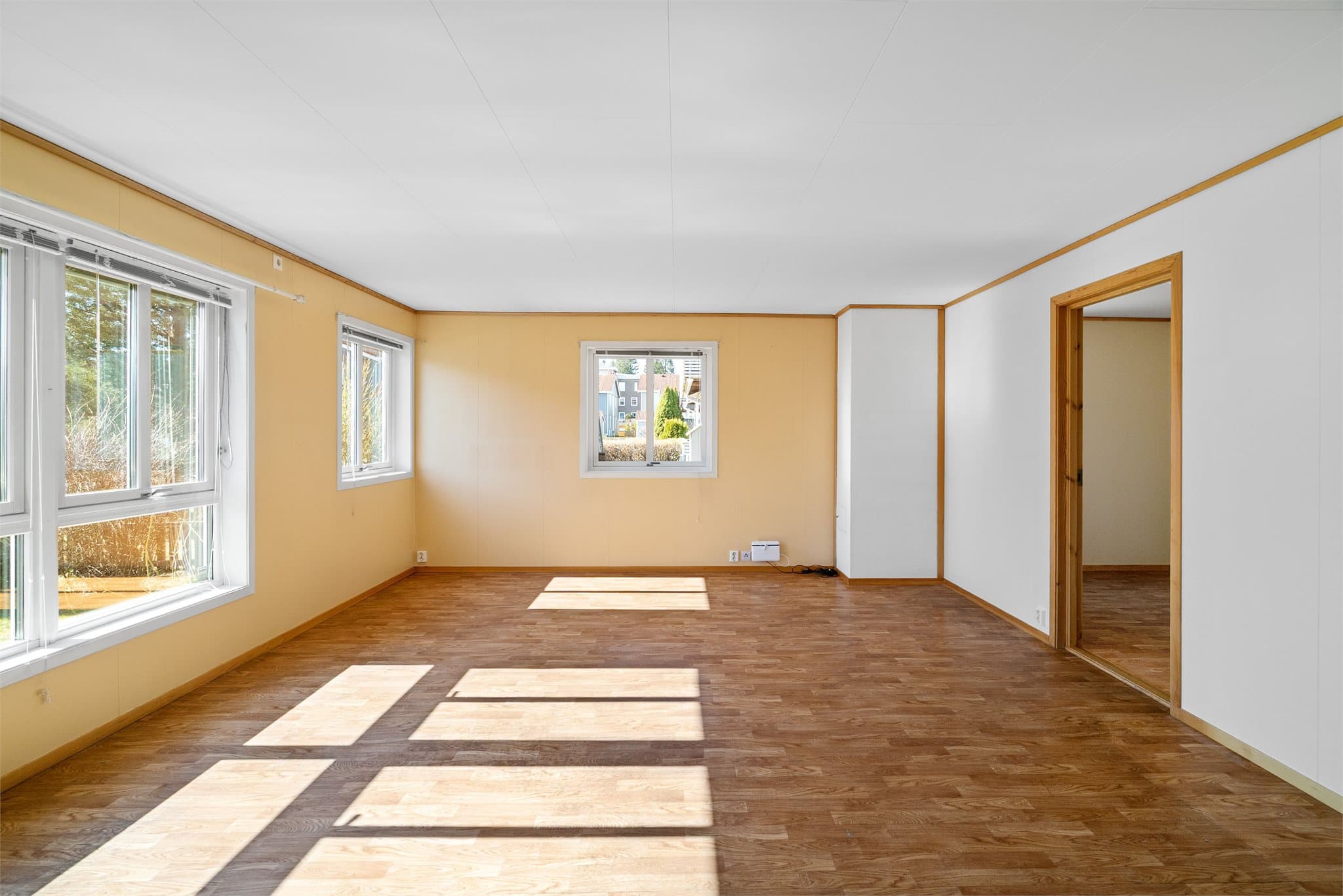 Leiligheten har en lys og romslig stue med store vindusflater som slipper inn rikelig med naturlig dagslys.