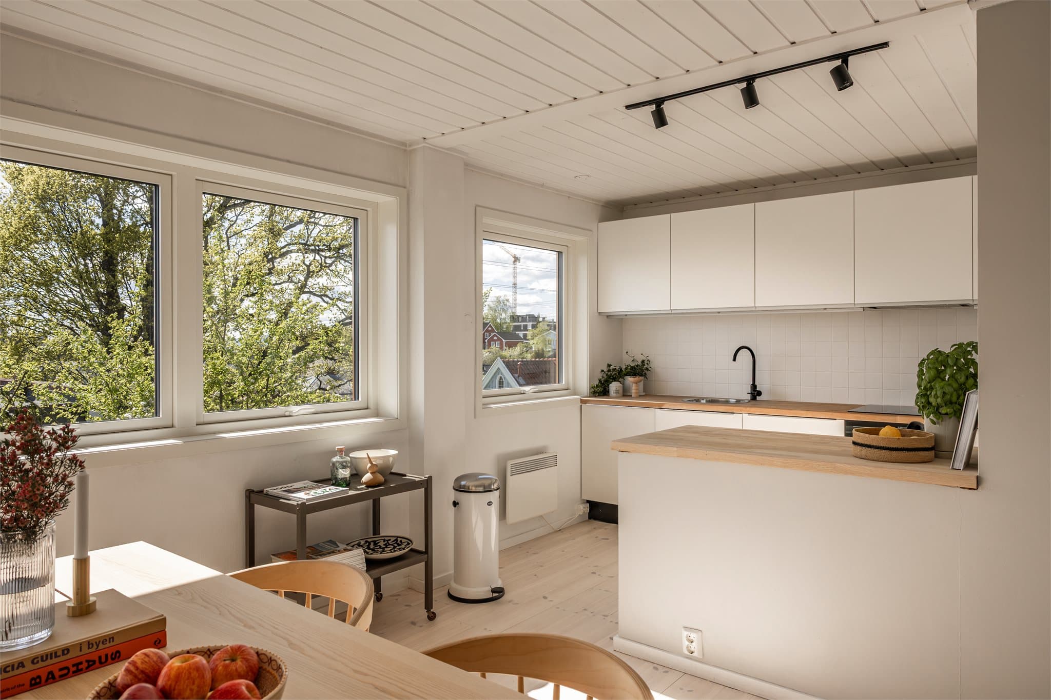 Et romslig kjøkken med flott utsikt i åpen løsning mot stuen, men med en liten "halvvegg" som likevel gir et fint skille.