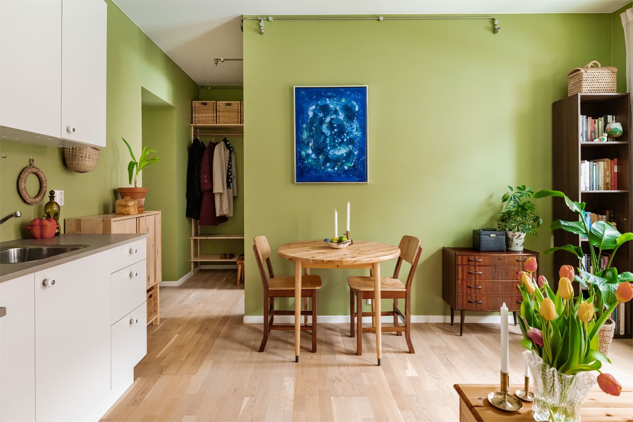 Veggene er malt i en lun grønnfarge som gir oppholdsrommet et varmt preg.