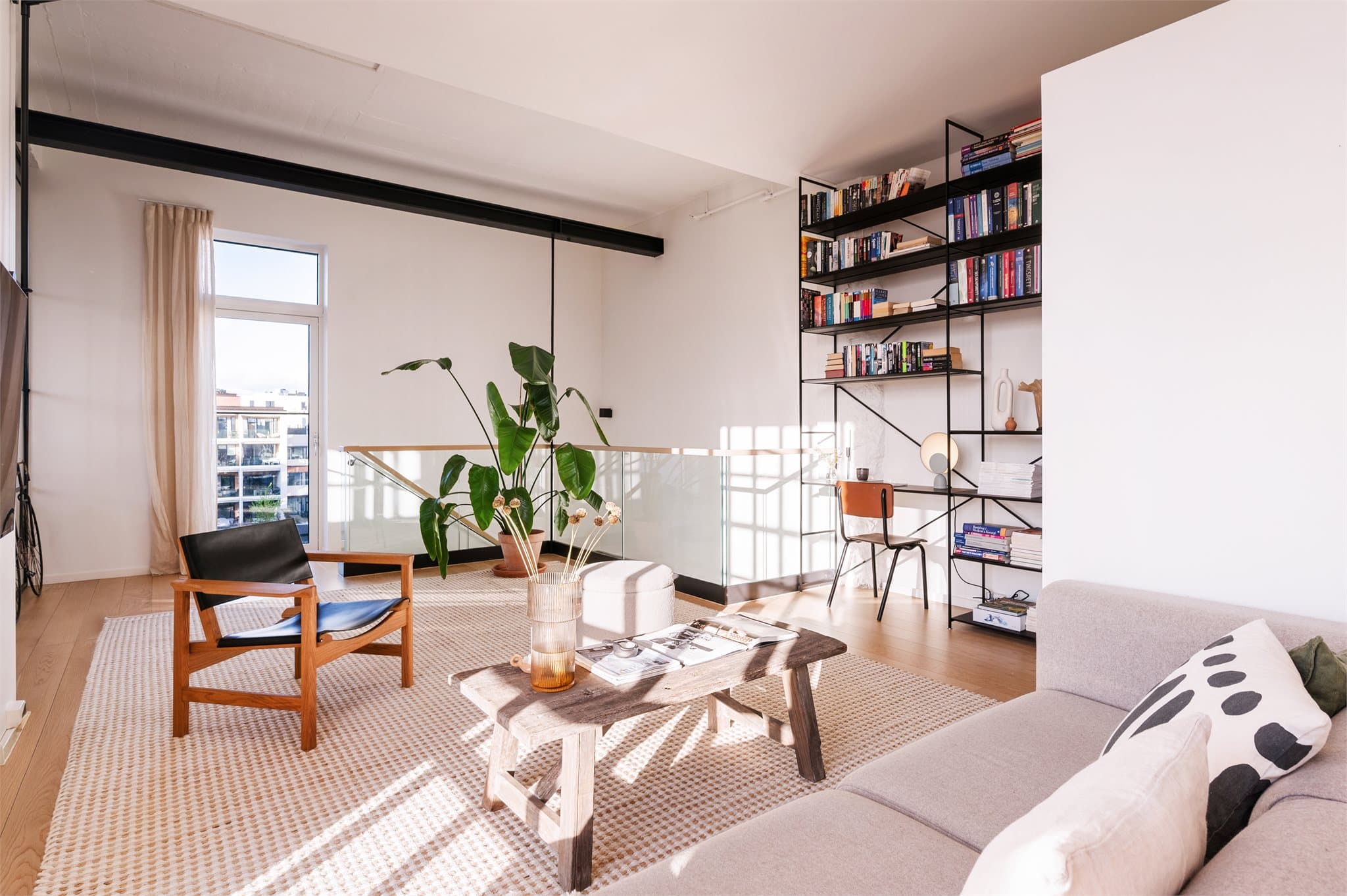 Store vindusflater slipper inn rikelig med dagslys og understreker den lyse og luftige stilen i rommet.