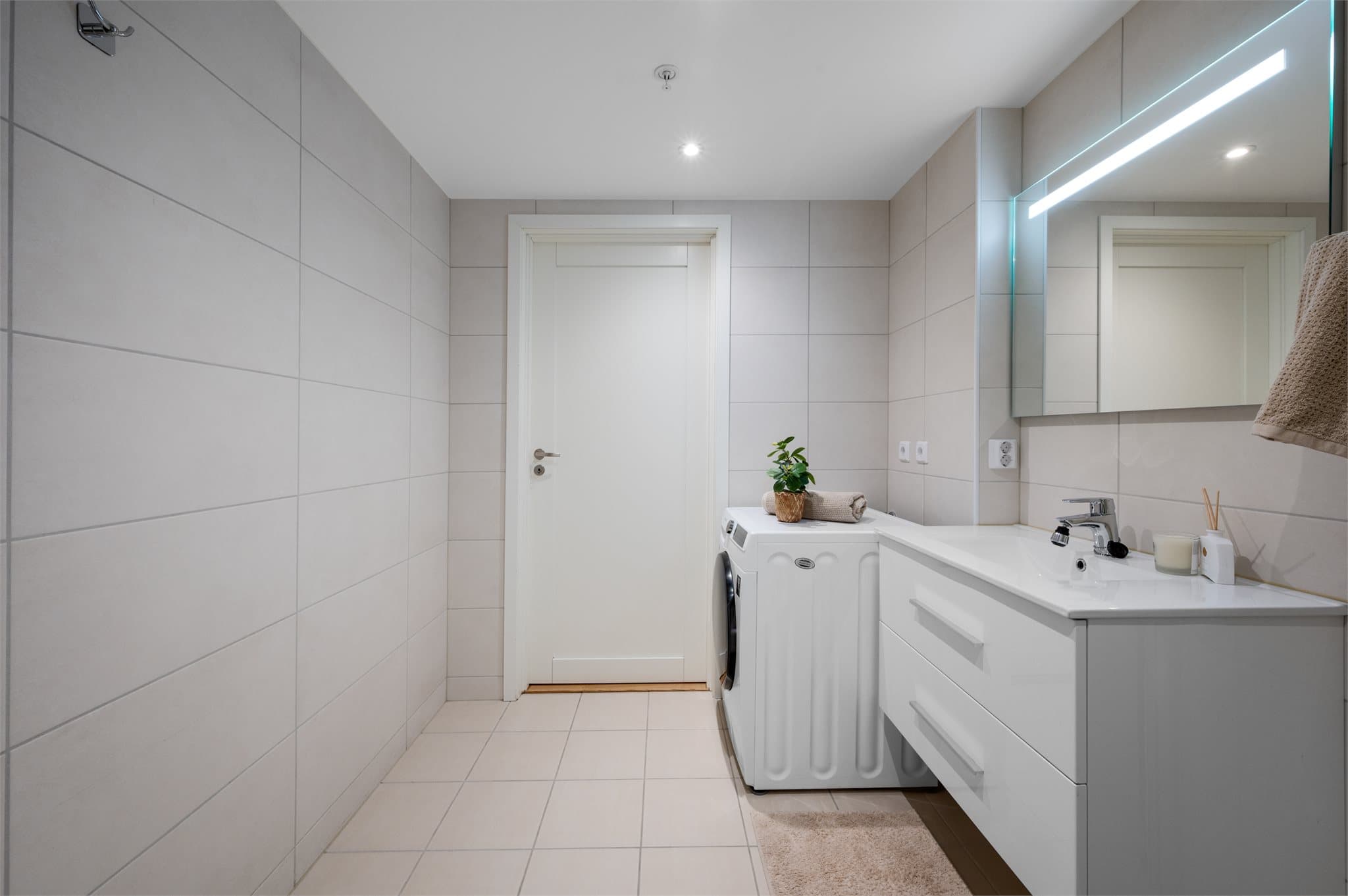 - Badet inneholder heldekkende servant, vegghengt toalett, dusj med innfellbare dusjdører og opplegg for vaskemaskin -