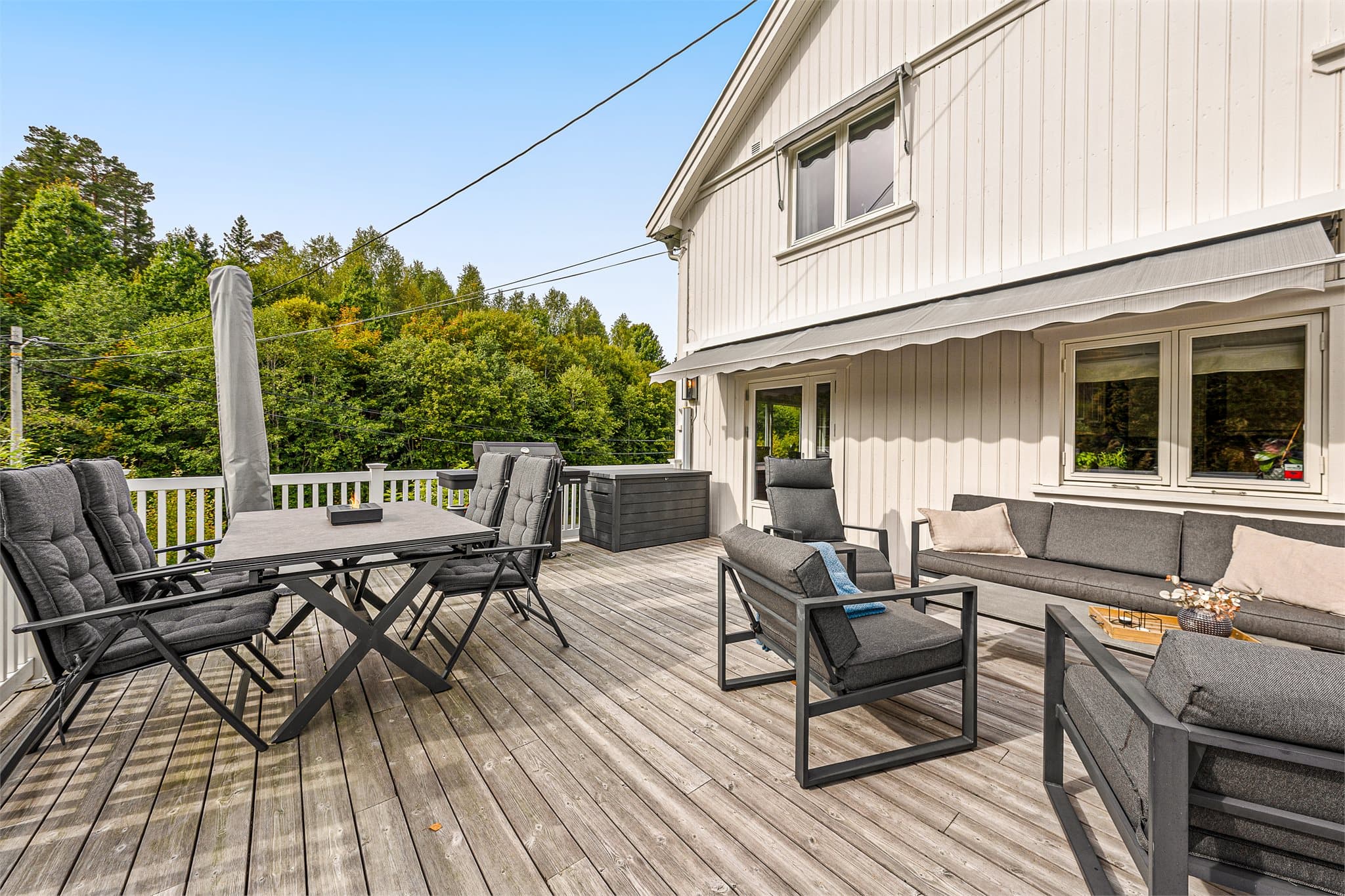 Romslig terrasse som forlenger boligens oppholdsarealer gjennom sommerhalvåret.