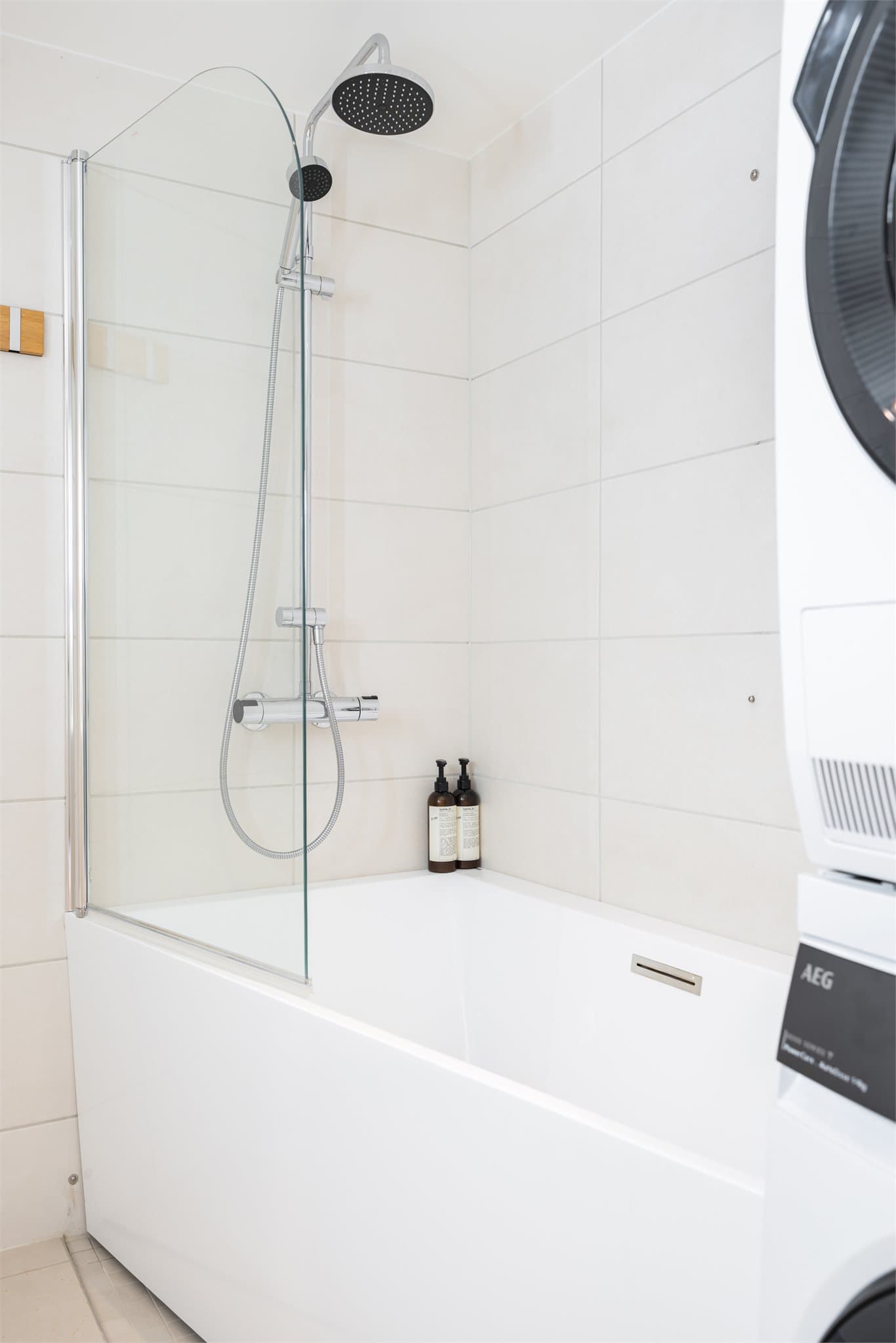 Dusjløsning i badekaret med en praktisk glassvegg.