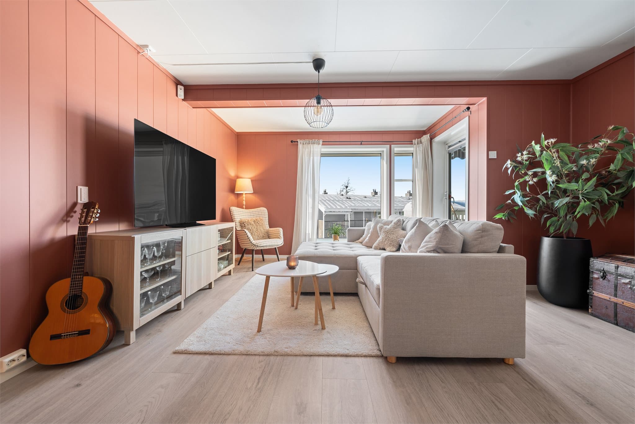 Stuen har store vindusflater og utgang til overbygd balkong.