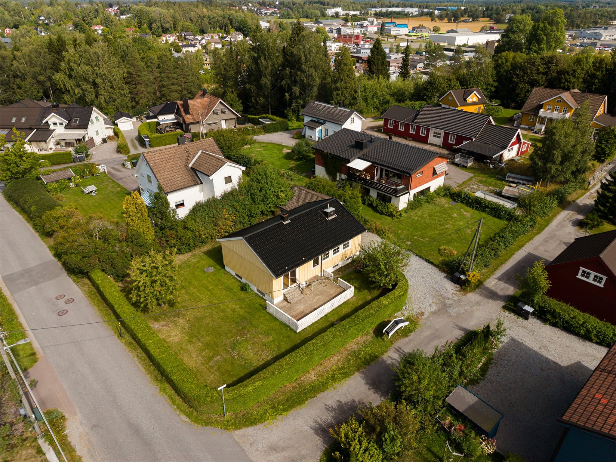 Eiendommen er pent opparbeidet med busker, beplantning og hekk.