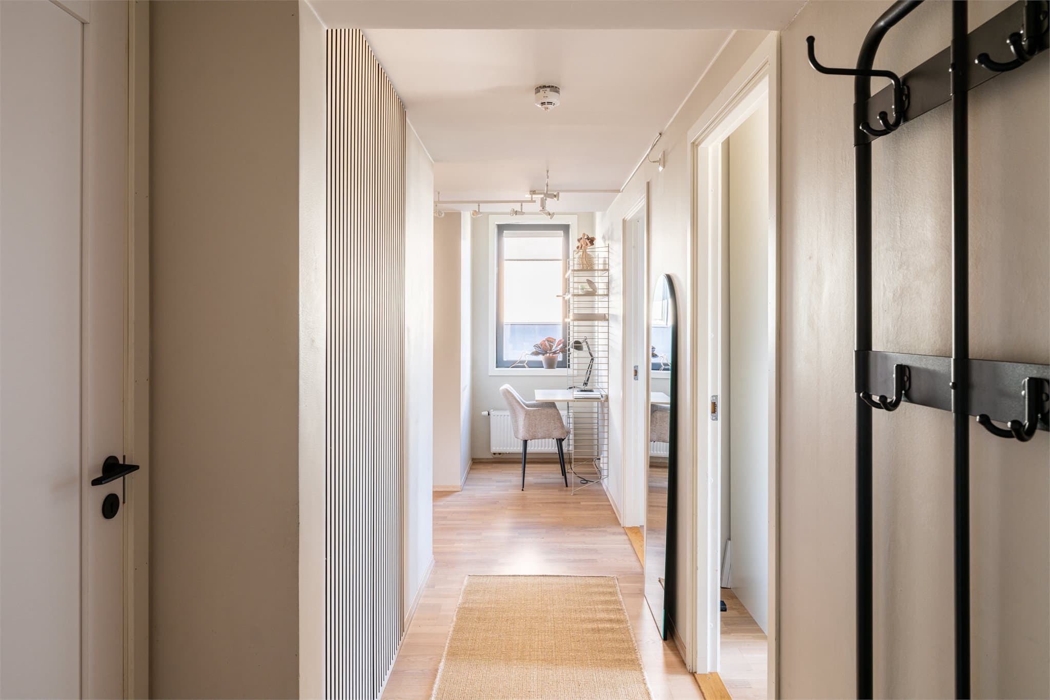 Boligen ønskes velkommen av en romslig entré med en gjennomført og moderne utforming. Spileveggen tilfører entréen et dekorativt særpreg, mens speil bidrar til en fin romfølelse.