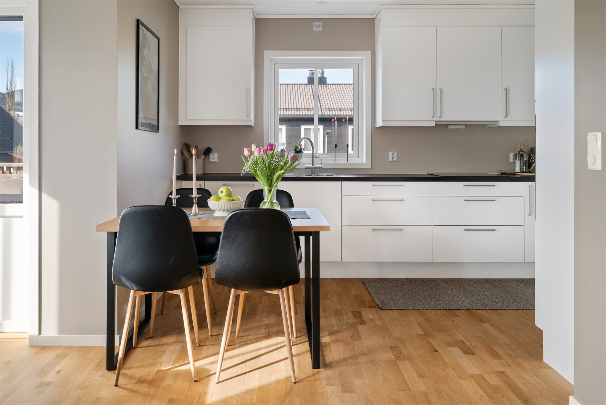 Den åpne løsningen mellom kjøkken og oppholdsrom gir en sosial og luftig romfølelse.