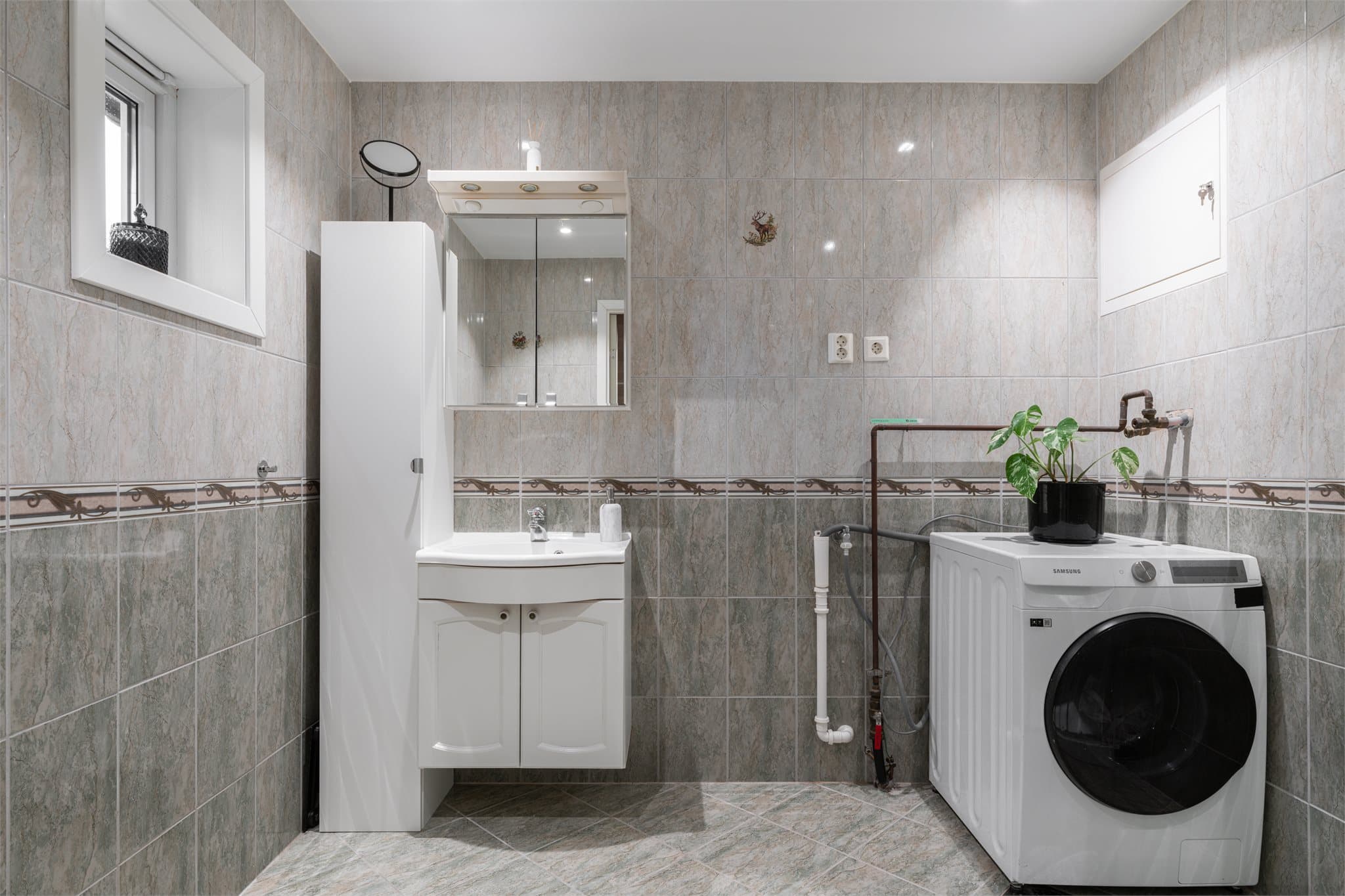 Lyst, flislagt baderom med varmekabler i gulv.