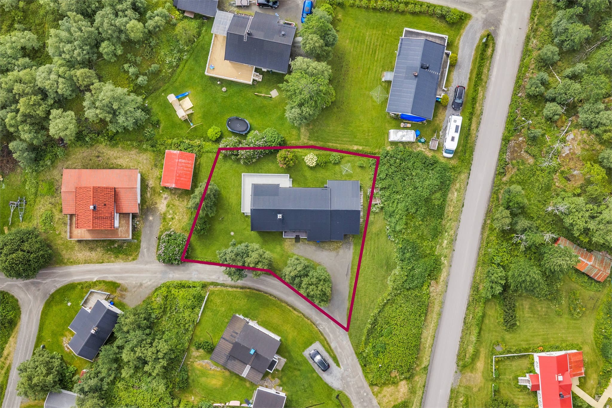 Eiendommen ligger på en romslig og relativt flat tomt.