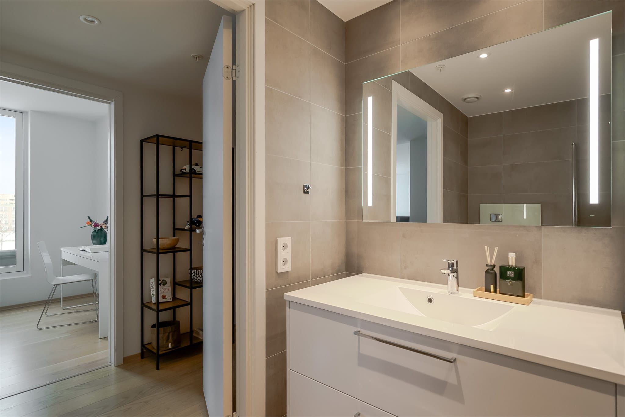 Romslig servantinnredning gir rikelig med oppbevaringsplass, og speil med integrert belysning gir et moderne preg.