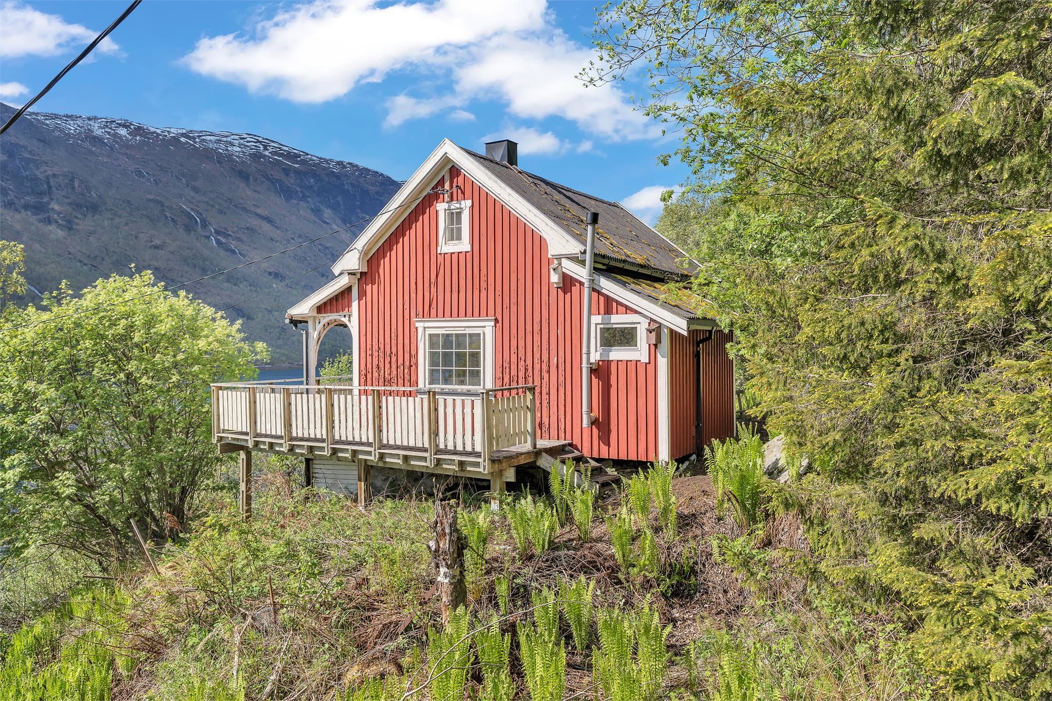 Fritidsbolig fra ca. 1930 med utsikt fra en stor veranda.